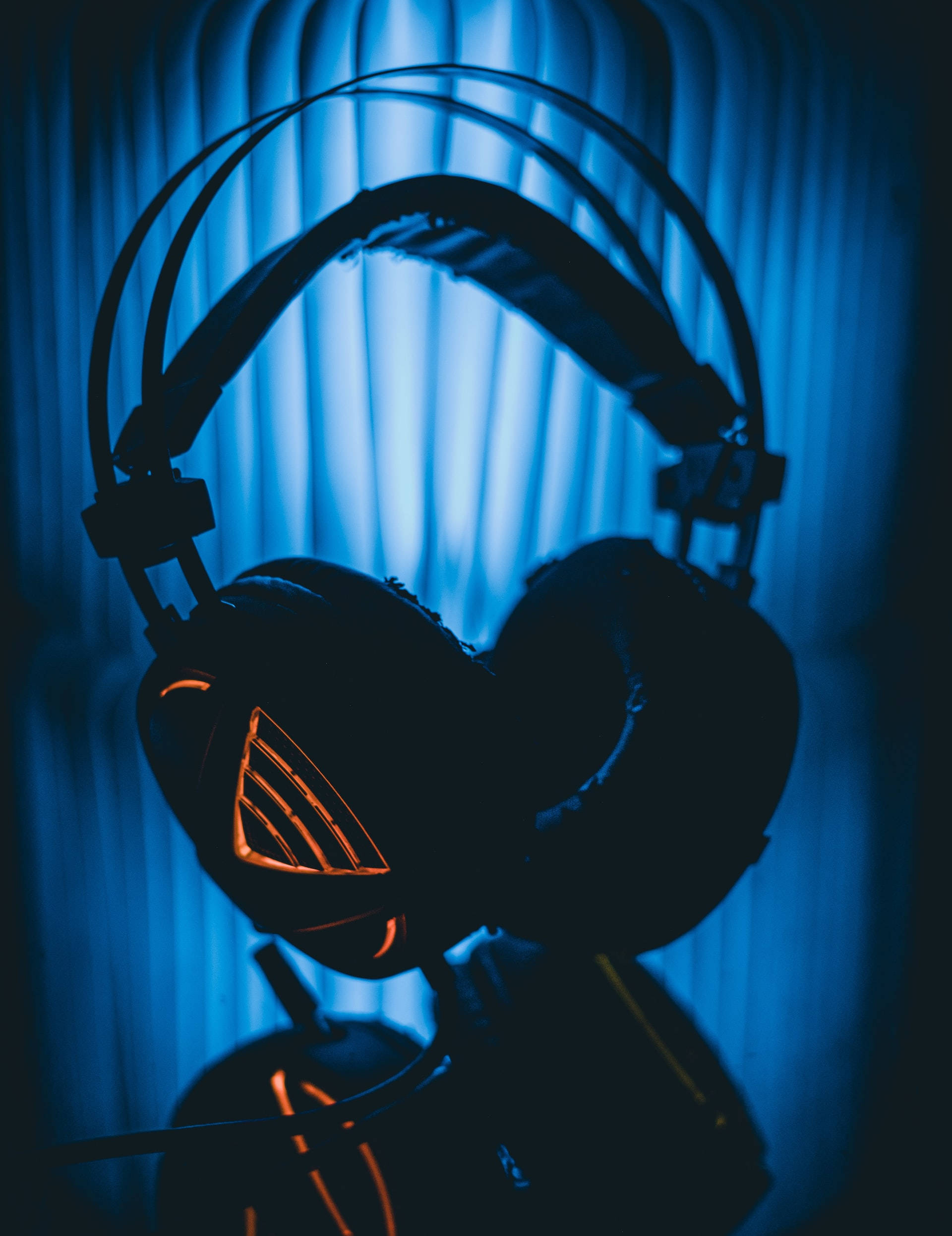 Neon Blue iPhone, gaming headphones, glowing orange accents, Full HD Phone Wallpaper