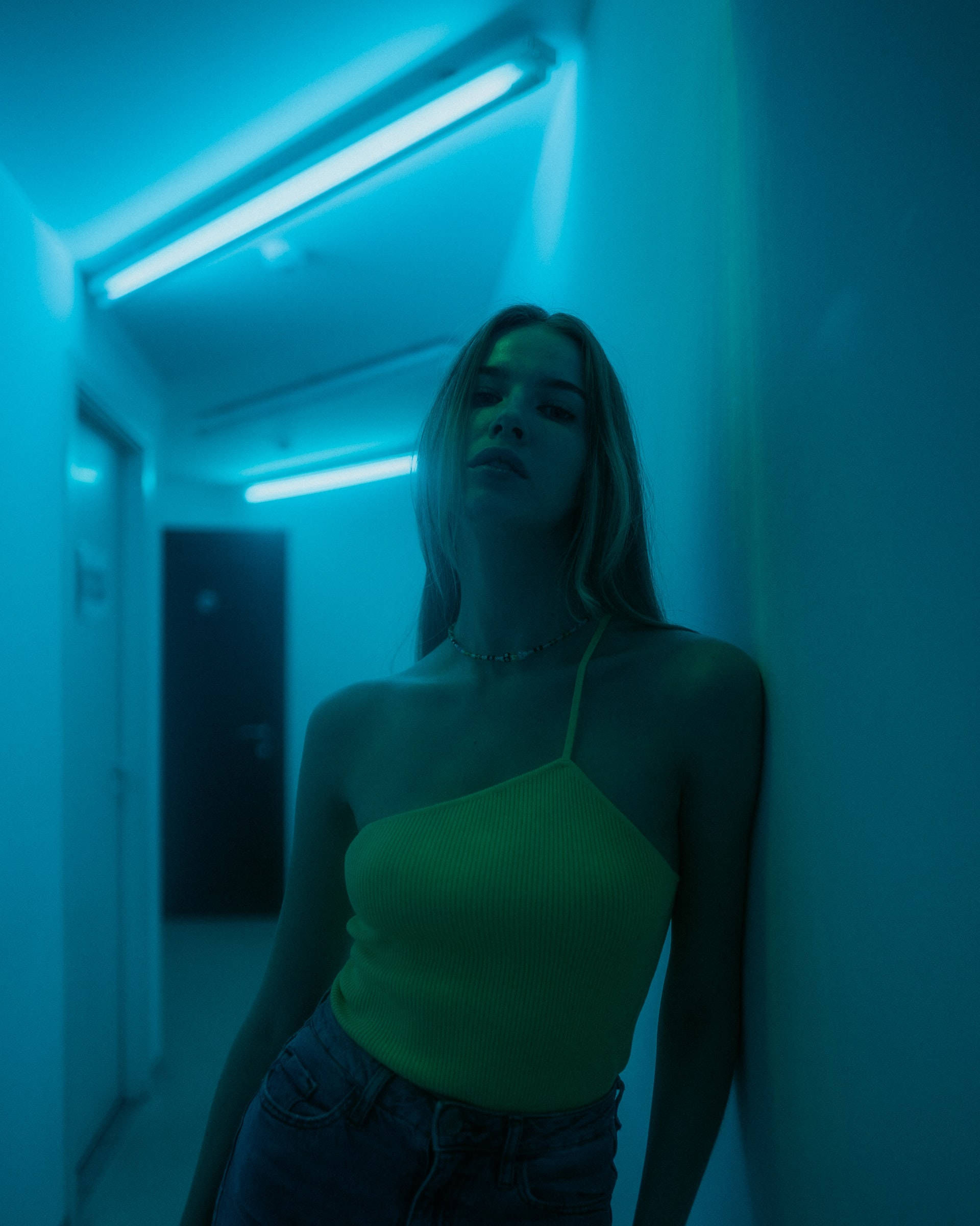 neon blue iPhone, neon green top, dimly lit hallway, Full HD Phone Wallpaper