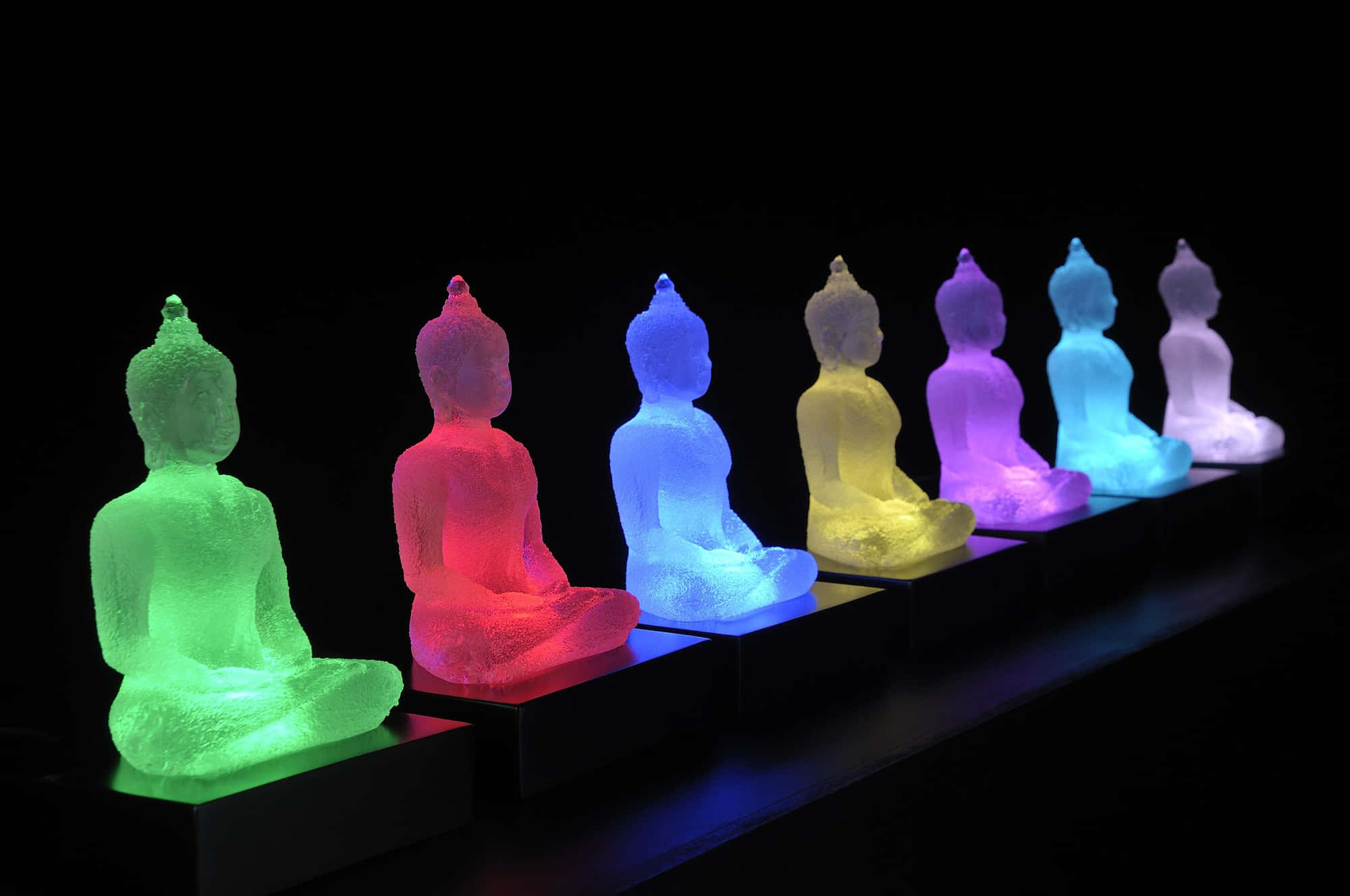 Illuminated Buddha Statuesin Row, seven glowing Buddha statues, rainbow hues, Full HD Desktop Wallpaper