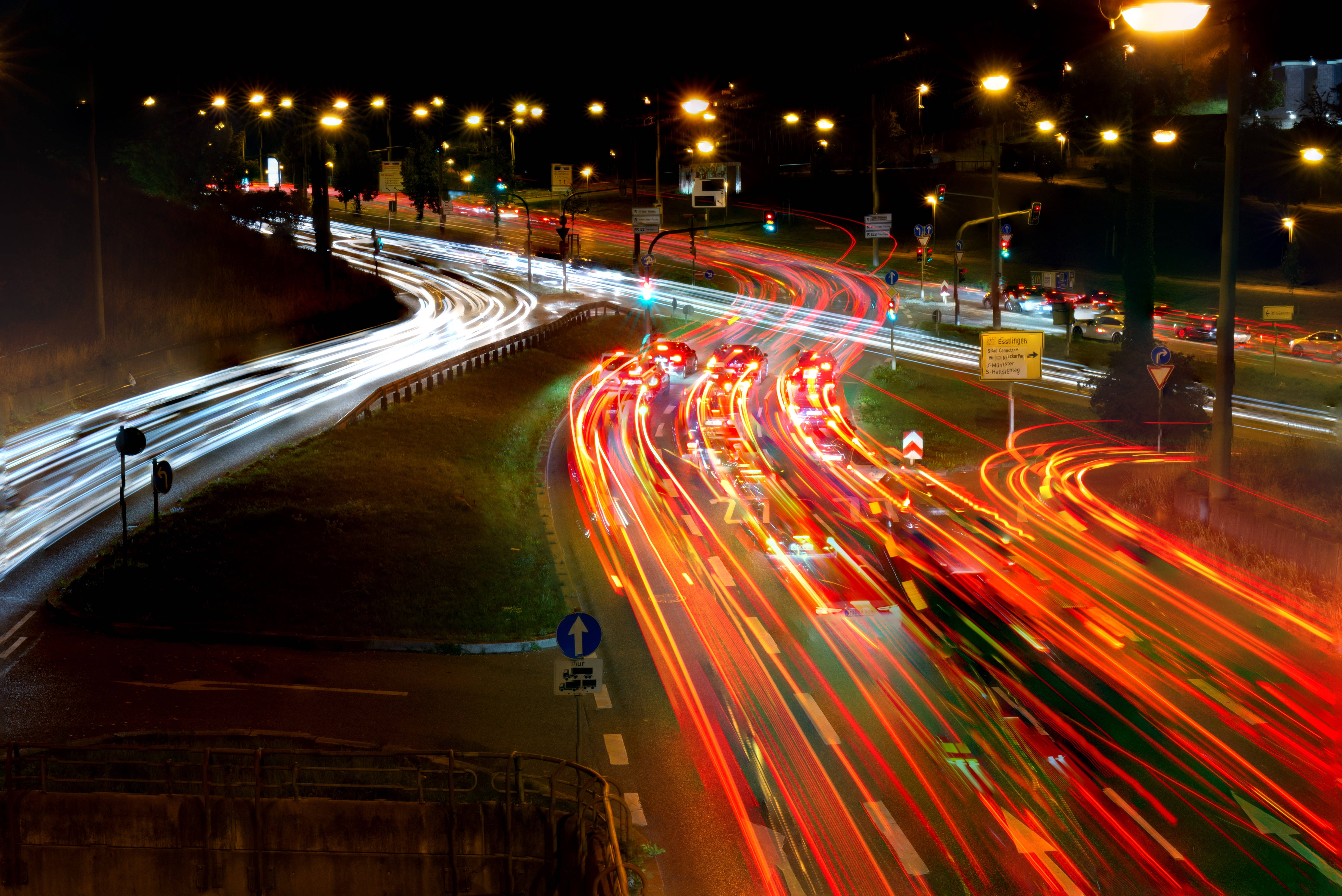 Neon Cars Highway, nighttime urban highway interchange, glowing red and white light trails, 5K Desktop Wallpaper