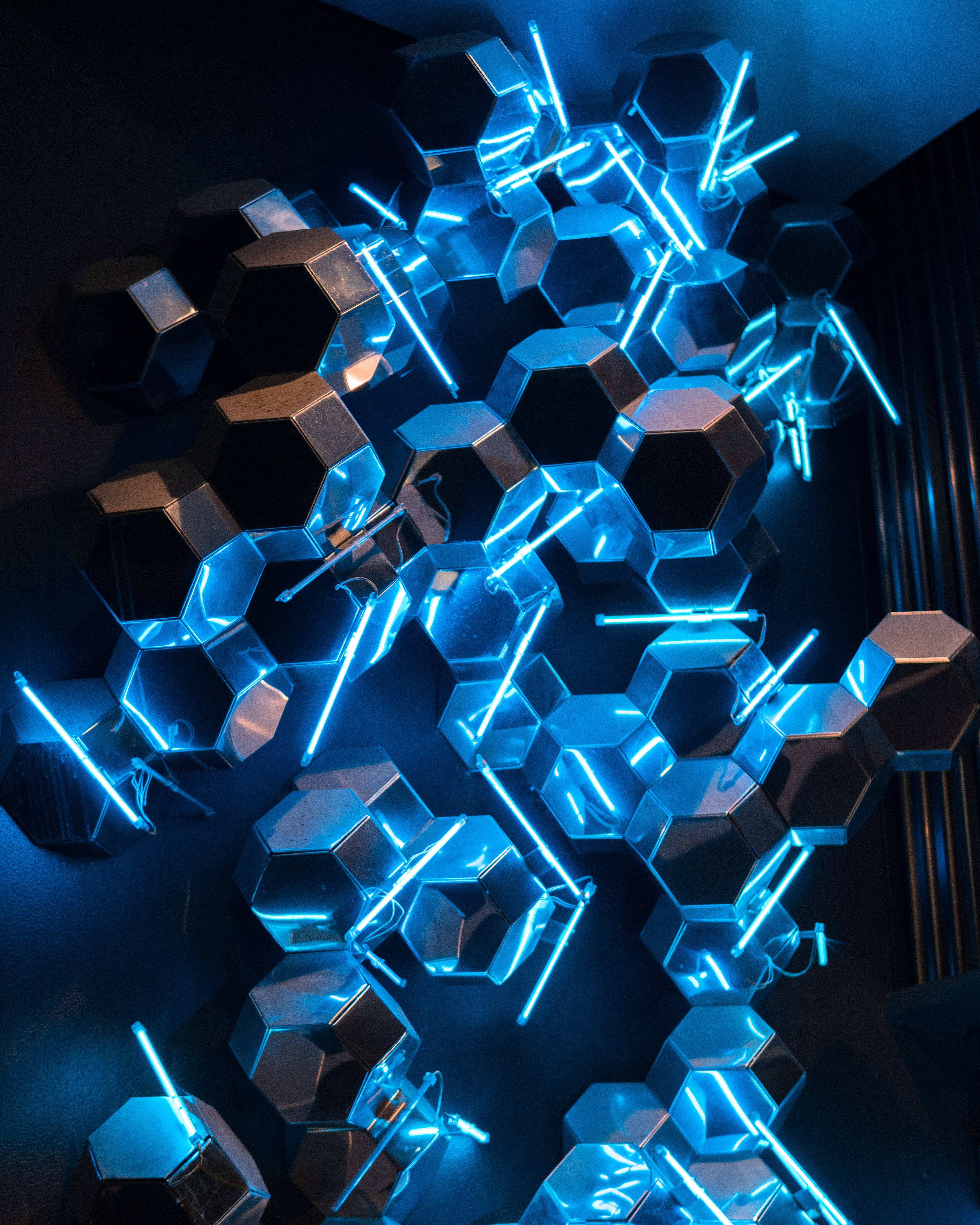neon light beams, glowing blue hexagonal panels, dark interior, 4K Phone Wallpaper