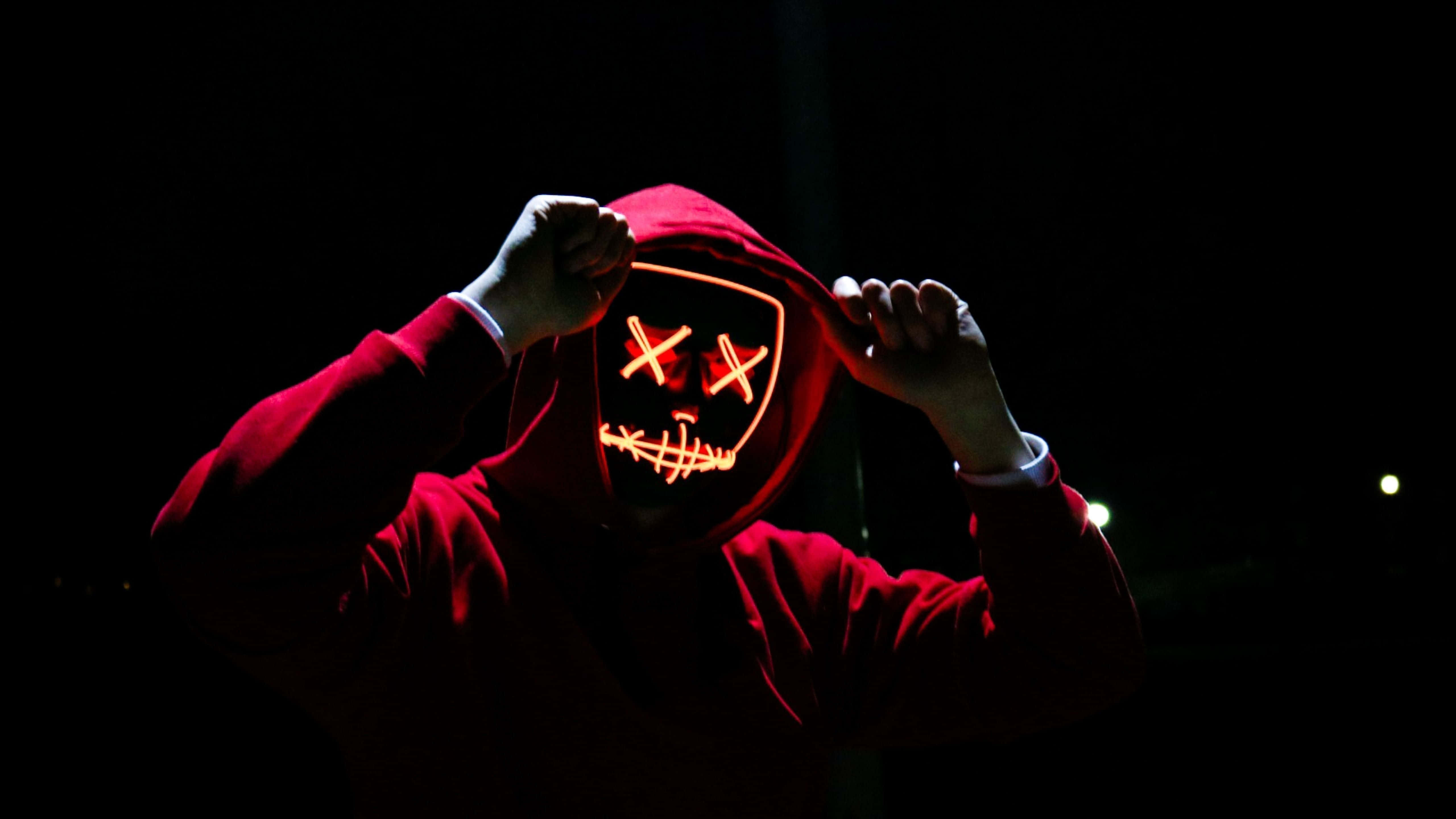 Neon Mask, red hoodie, glowing orange LED mask, 5K Desktop Wallpaper