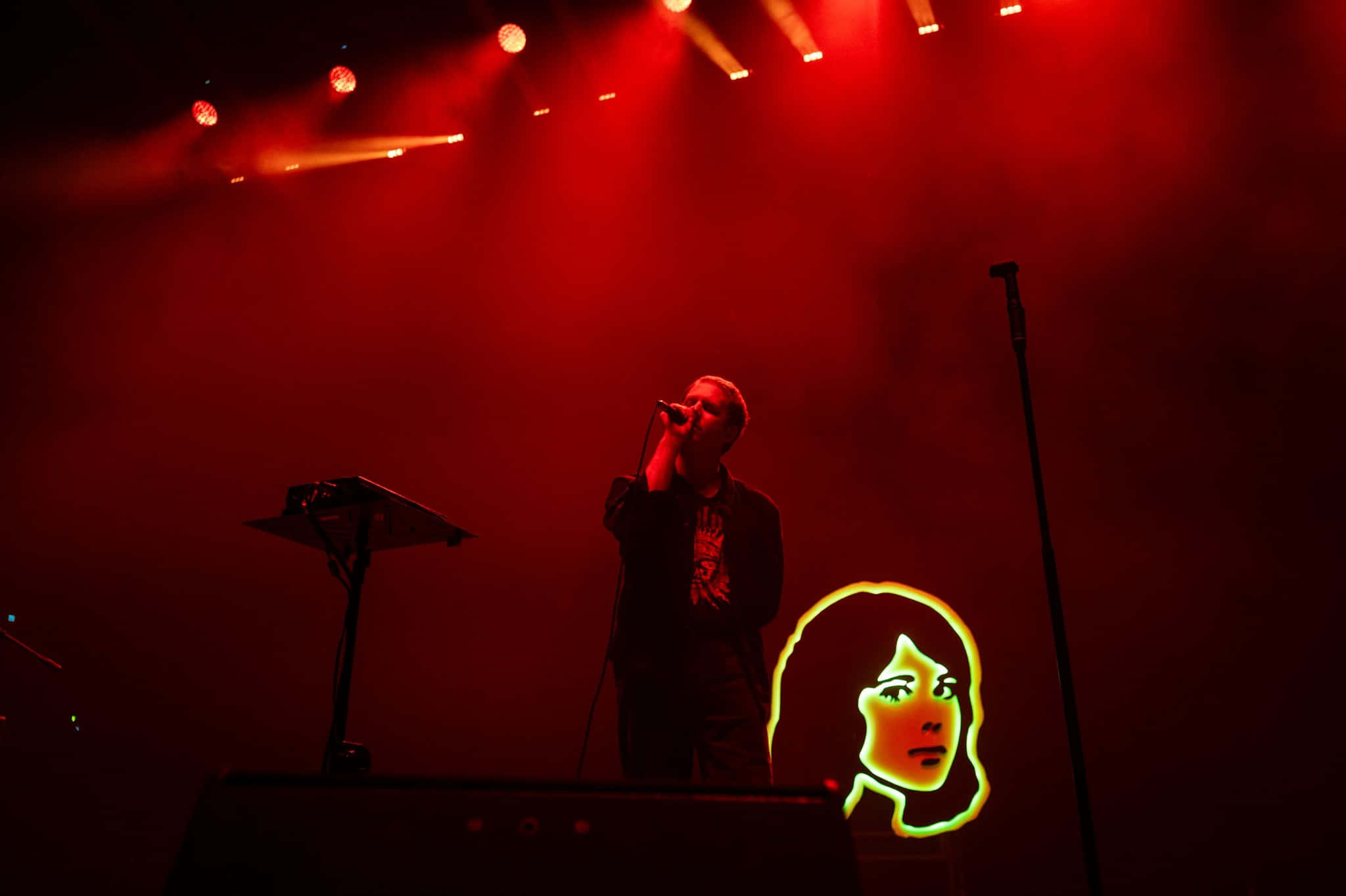 concert performance, neon face graphic, smoky stage, Full HD Desktop Wallpaper