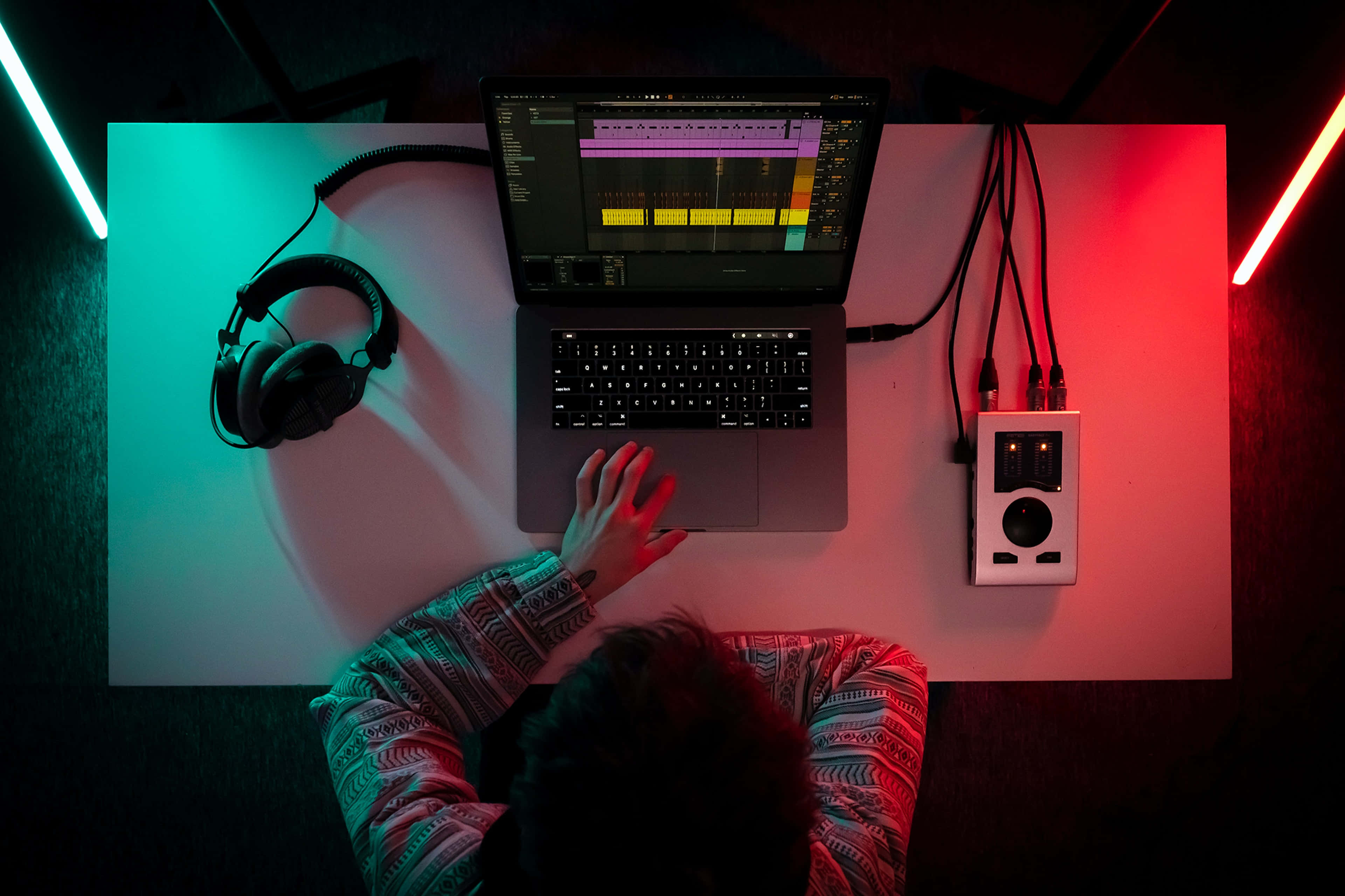 Neon Music, vibrant red and teal neon lighting, laptop with audio software, 4K Desktop Wallpaper