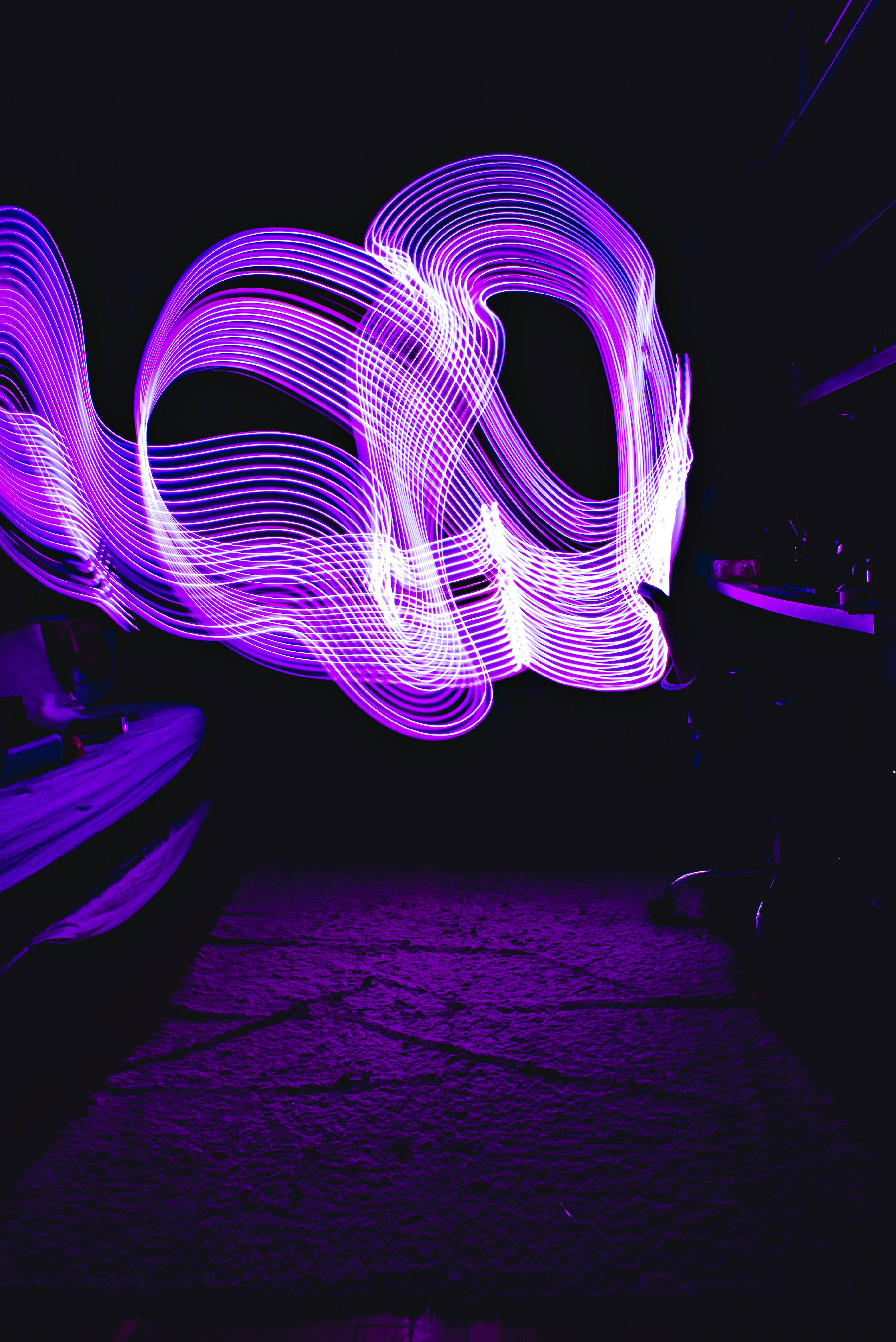 Neon Purple iPhone, vibrant purple light trails, dark background, 5K Phone Wallpaper