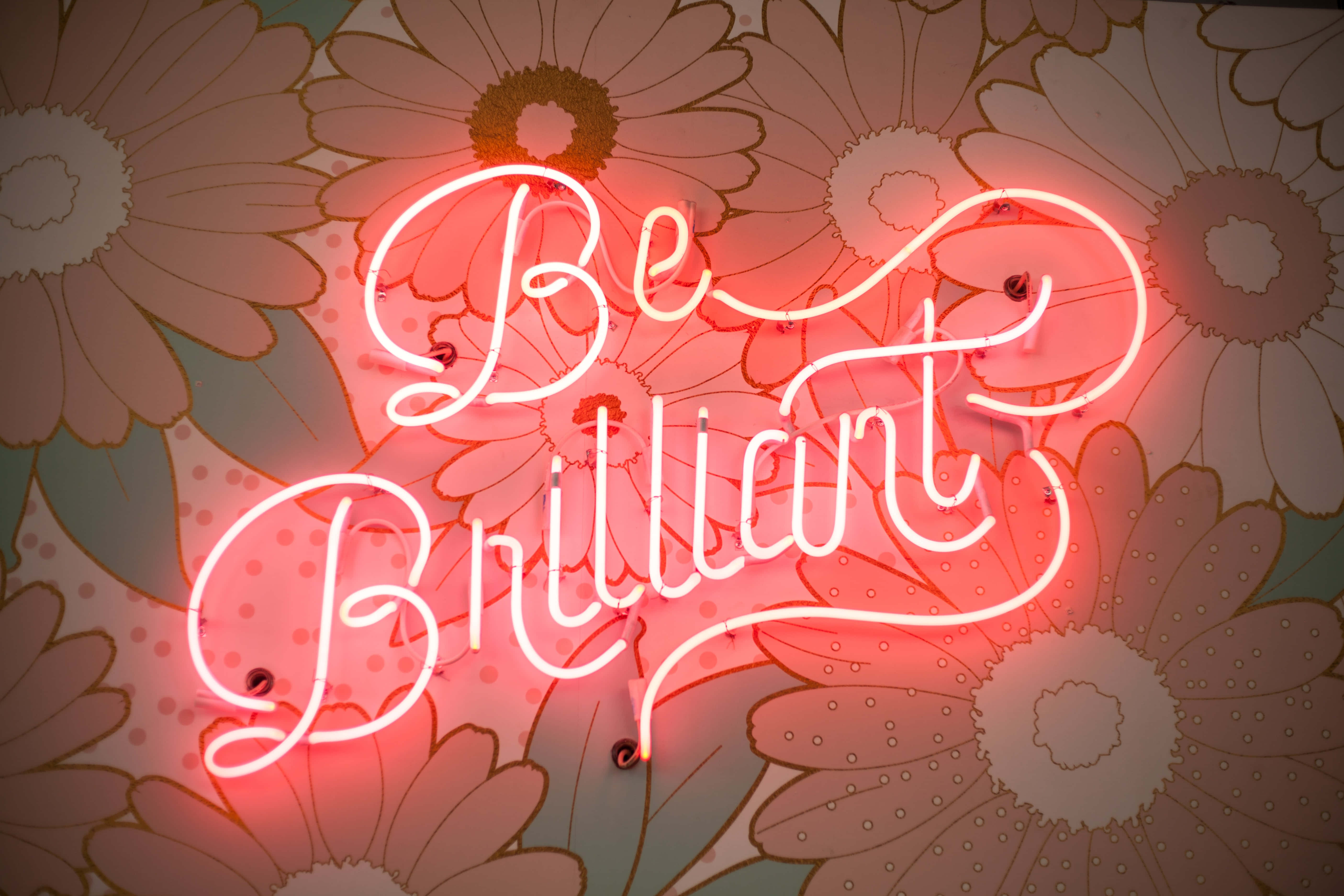 Be Brilliant, glowing red neon sign, vintage floral wallpaper, 5K Desktop Wallpaper