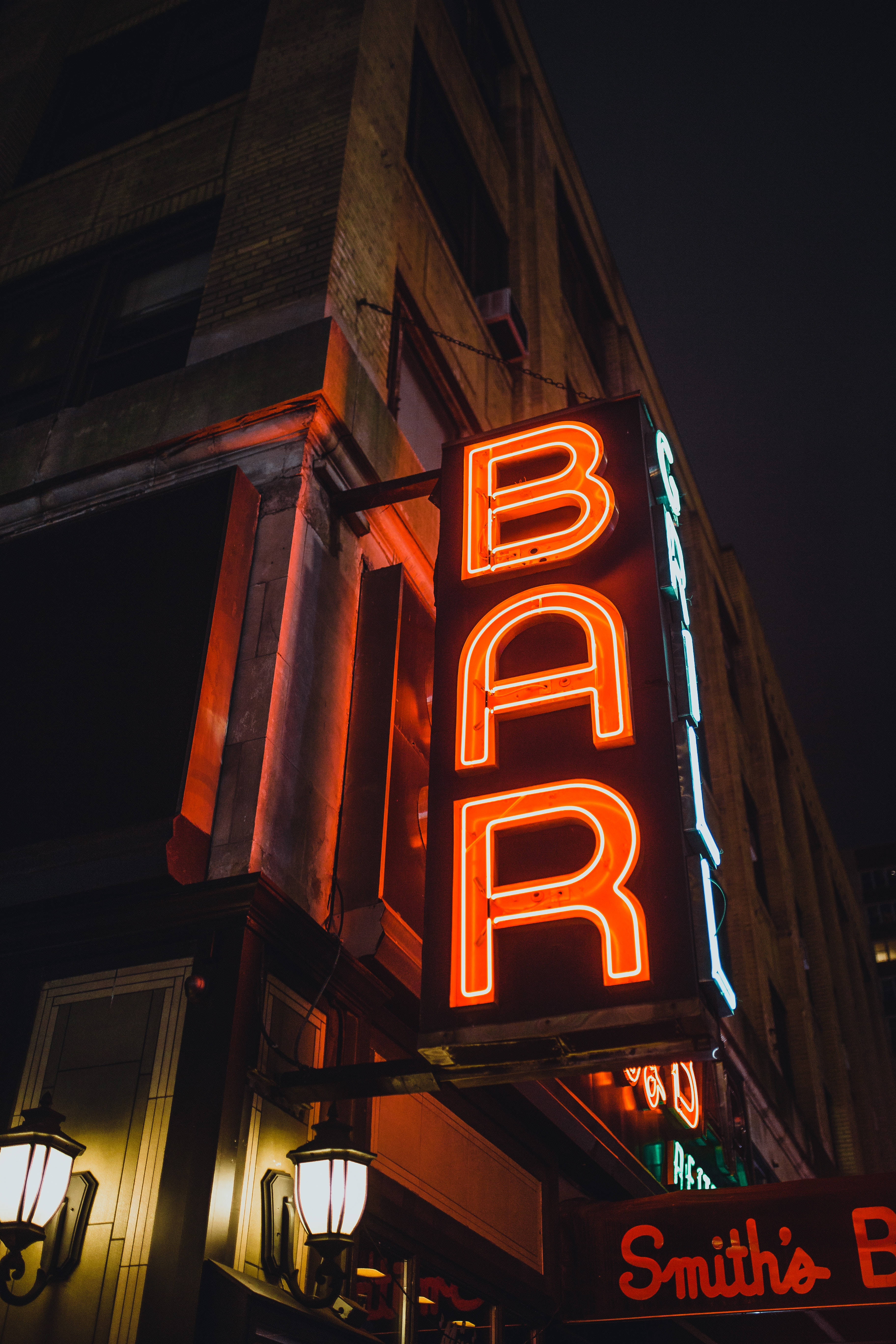 large bar neon sign, orange neon, brick building facade, 5K Phone Wallpaper