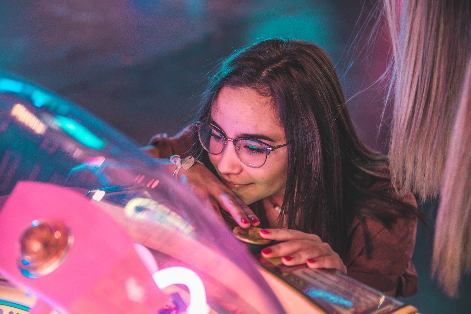 Vibrant Neon Smile, glowing pink arcade machine, neon-lit gaming venue, Full HD Desktop Wallpaper