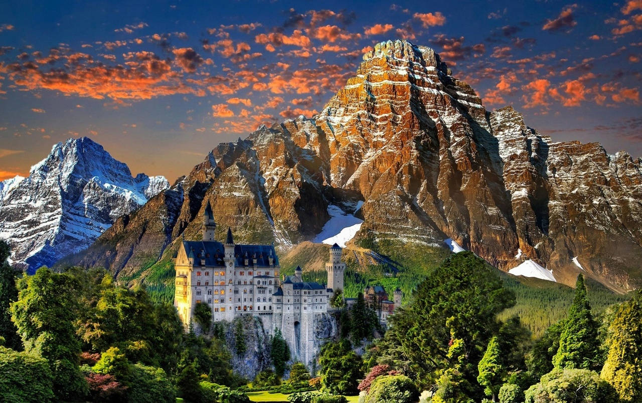 Neuschwanstein Castle, snow-capped mountains, fiery sunset sky, HD Desktop Wallpaper