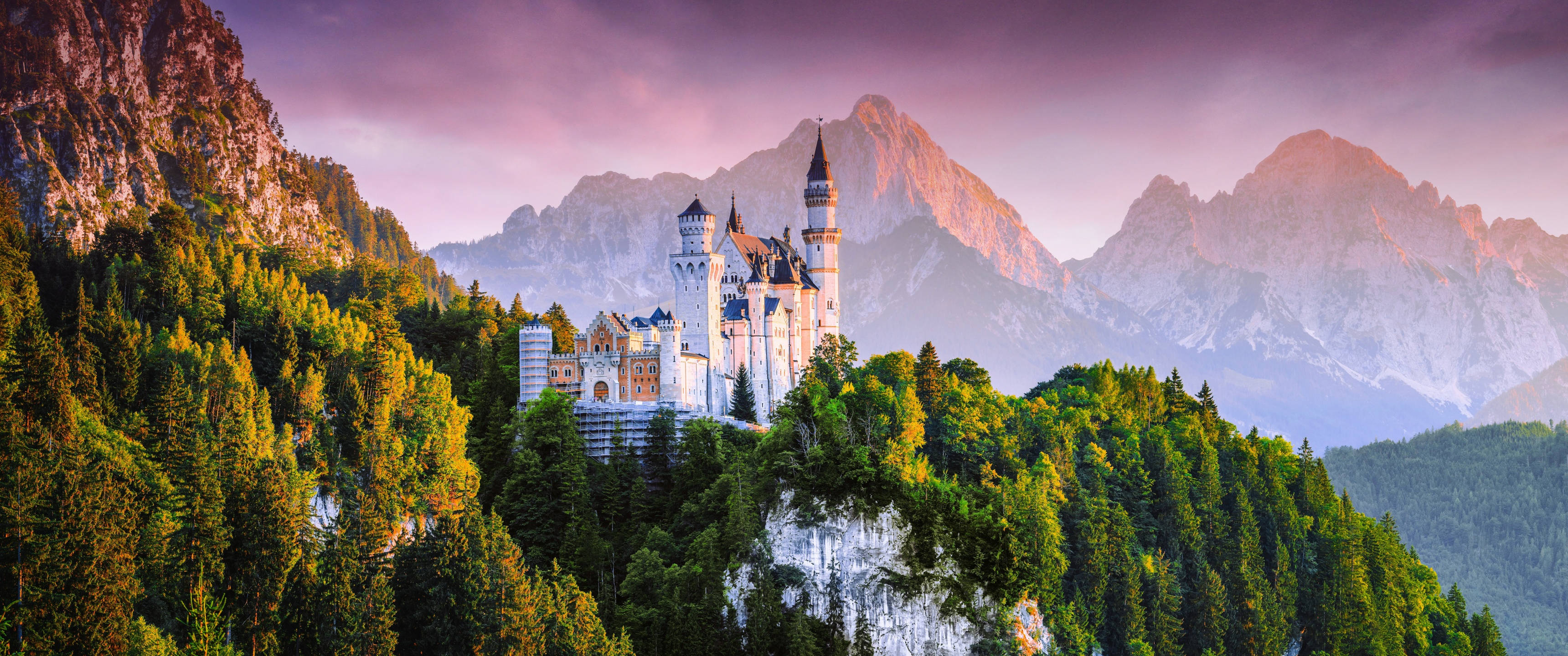 Neuschwanstein Castle, pink sky, snow-capped mountains, 2K Desktop Wallpaper