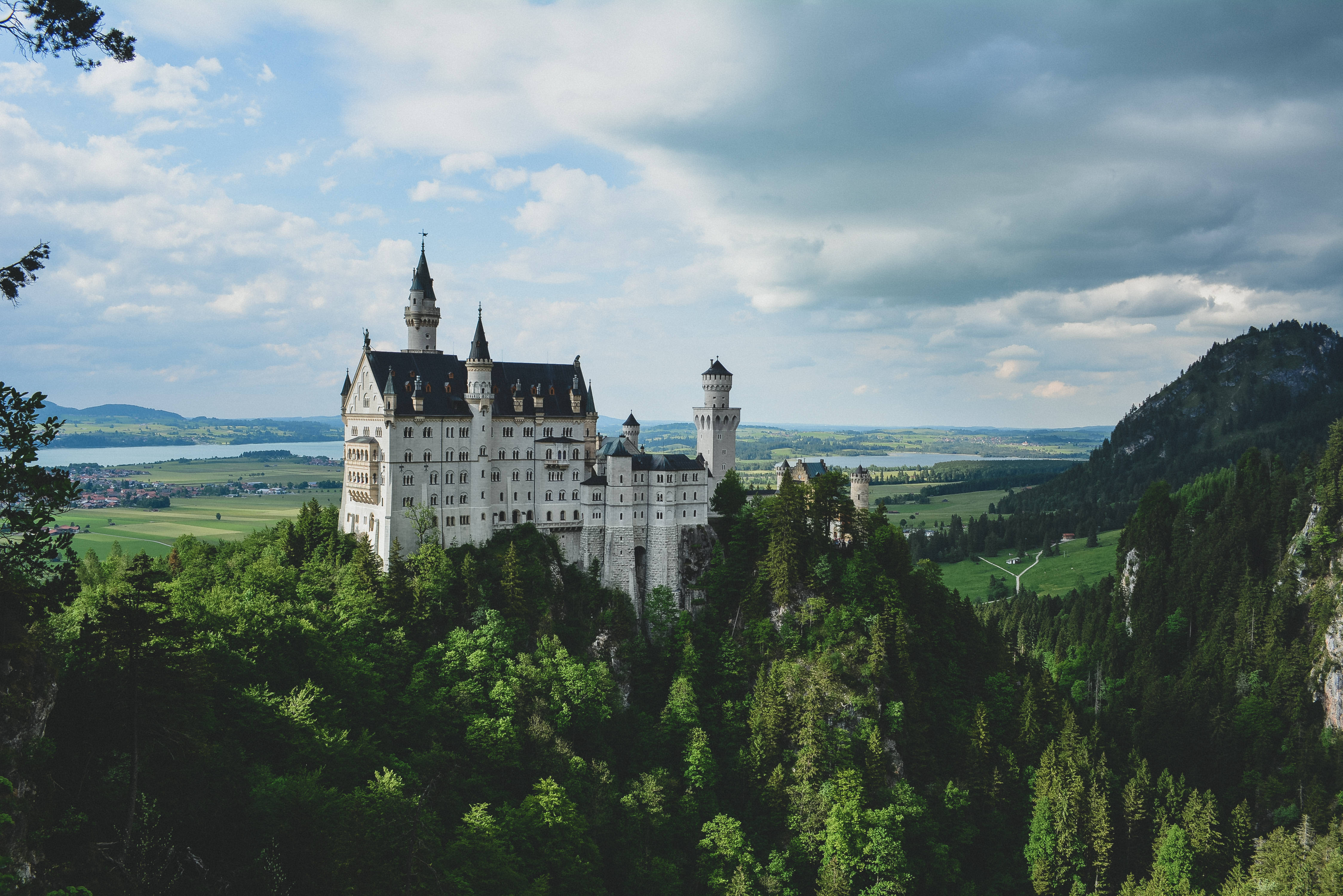 Neuschwanstein Castle, dark clouds overhead, white castle, 4K Desktop Wallpaper