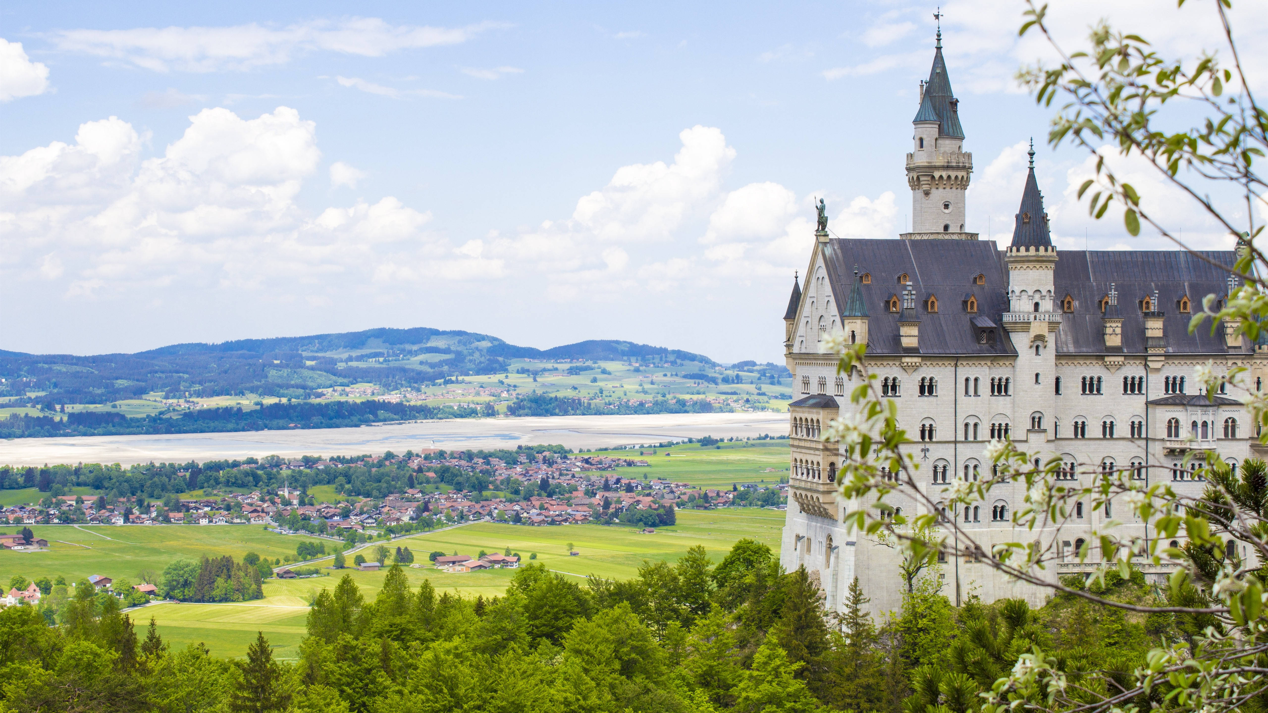 Neuschwanstein Castle, lush green forests, valley town, 5K Desktop Wallpaper