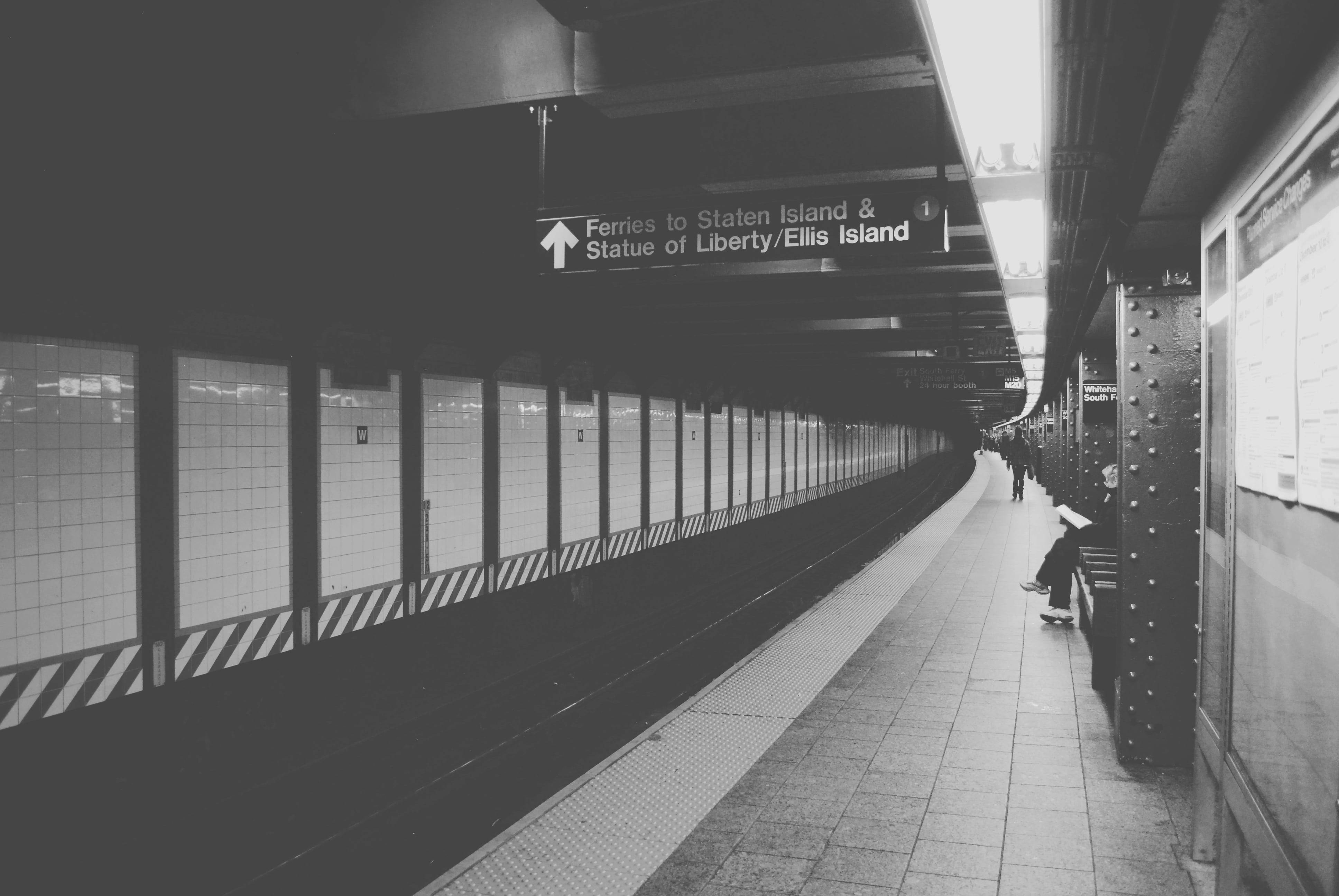 subway platform, lone person on a skateboard, sign pointing to Staten Island, 4K Desktop Wallpaper