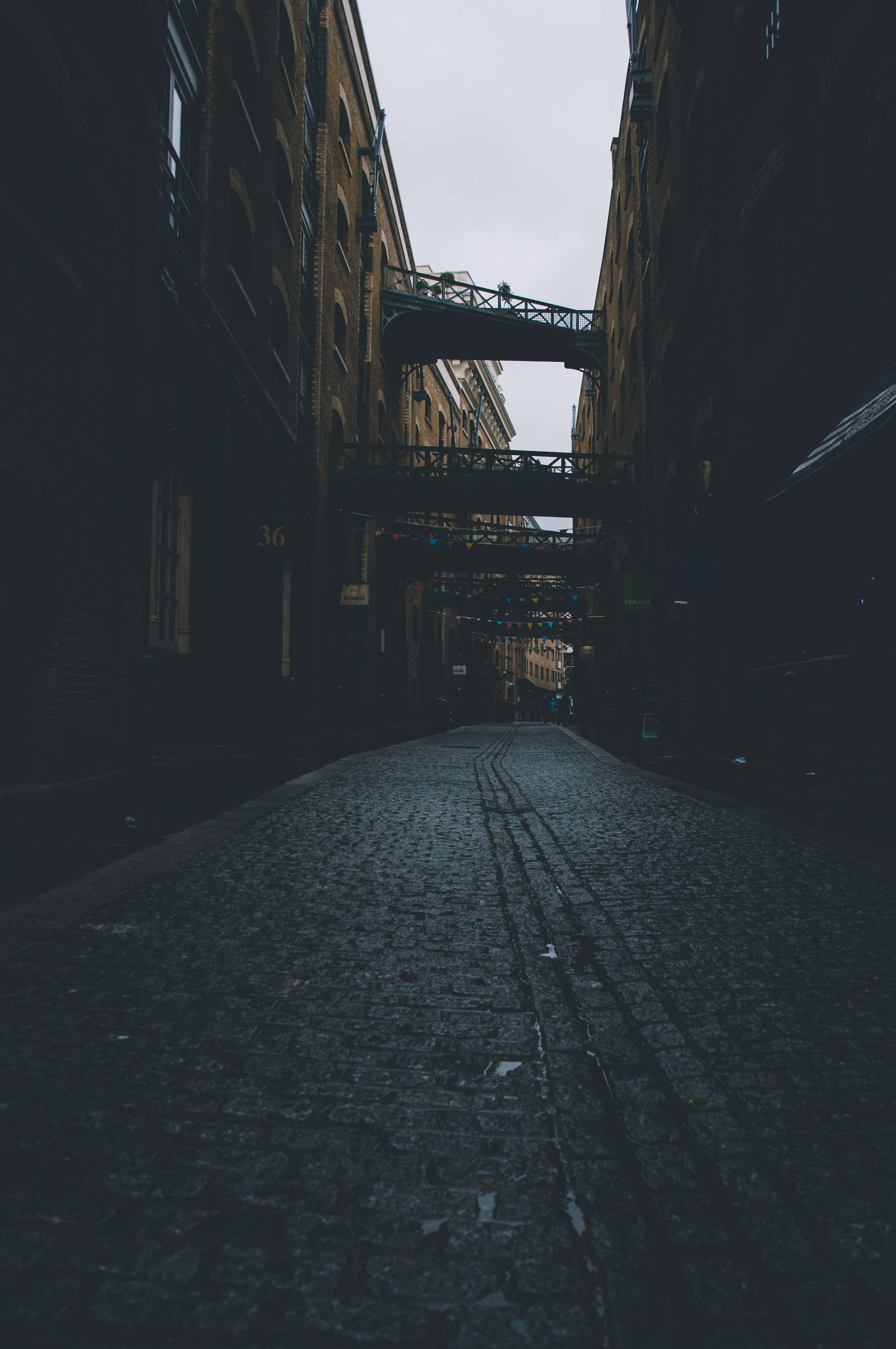 New York Street, cobblestone alleyway, tall brick buildings, 4K Phone Wallpaper