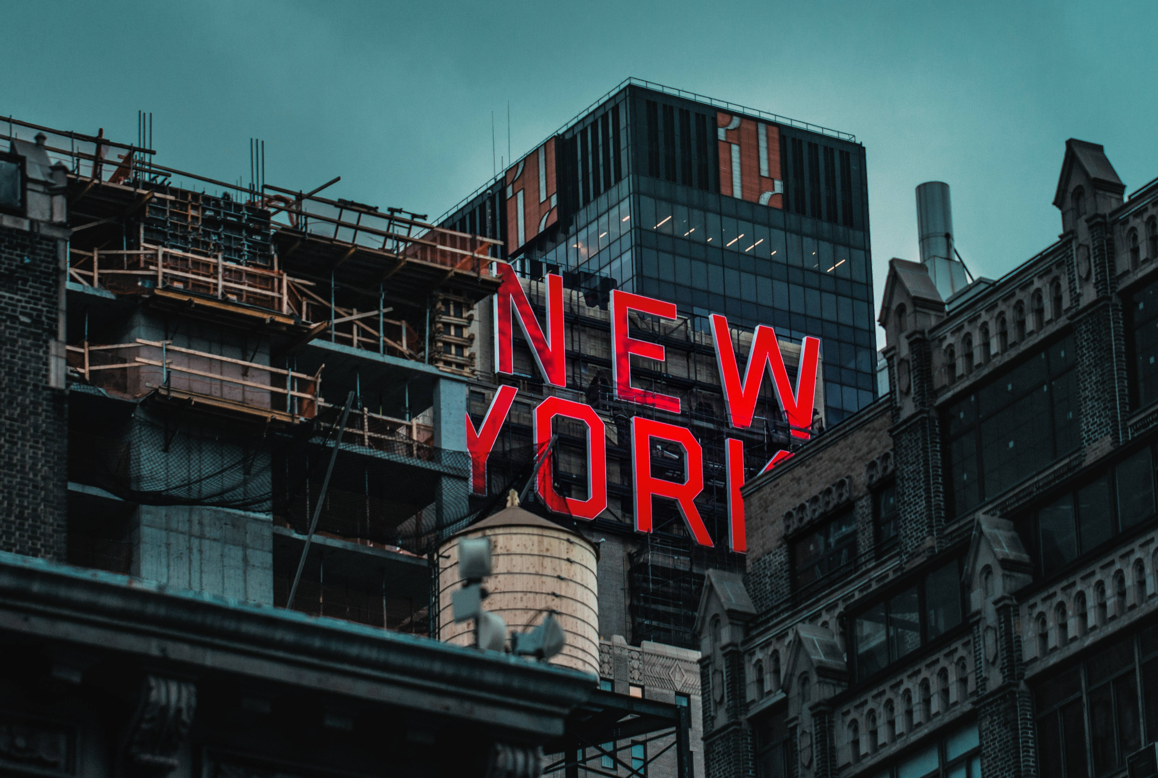 New York, red neon building sign, teal sky, 4K Desktop Wallpaper