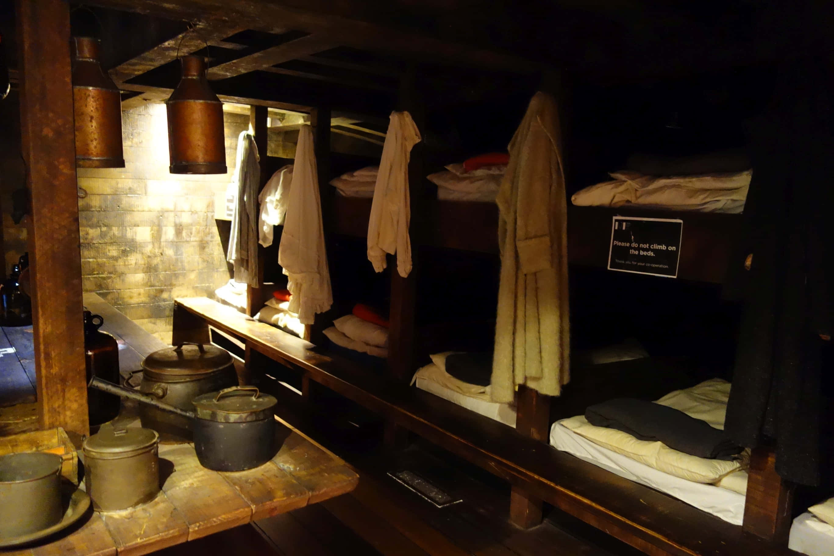 historical ship bunksand galley, wooden bunk beds, hanging clothes, 2K Desktop Wallpaper