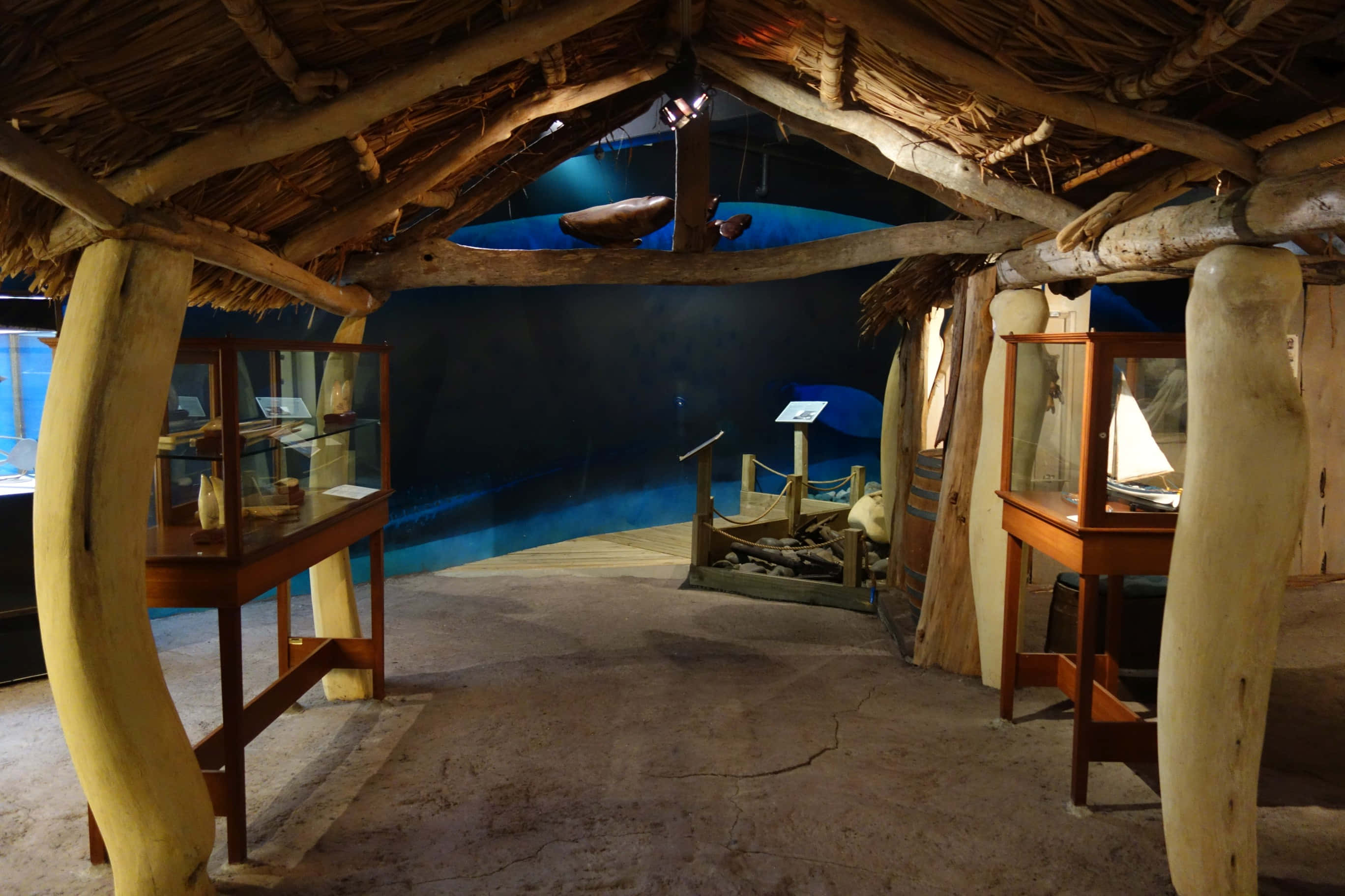 New Zealand Maritime Museum, thatched-roof hut, wooden pillars, 2K Desktop Wallpaper