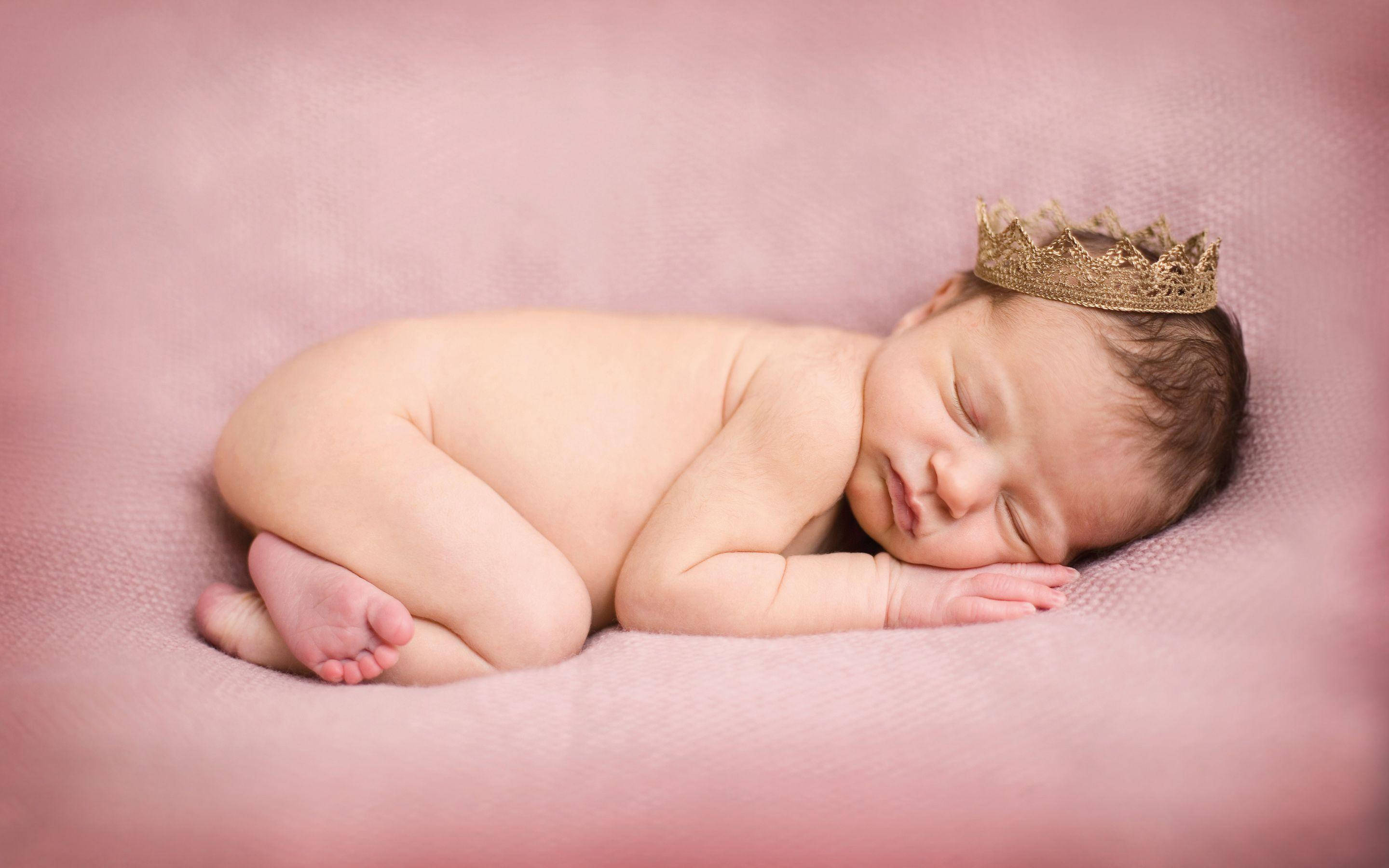 newborn baby, soft pink textured blanket, delicate gold crown, 2K Desktop Wallpaper