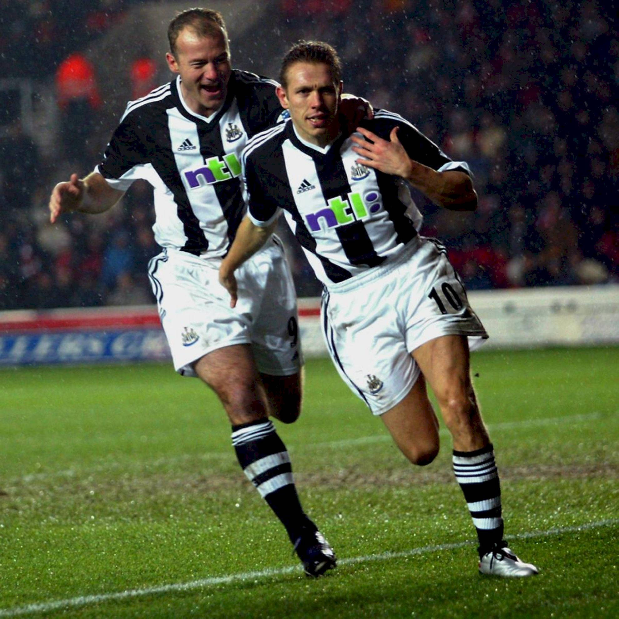 Newcastle United FC, black and white striped kits, rain-slicked pitch, Full HD Desktop Wallpaper