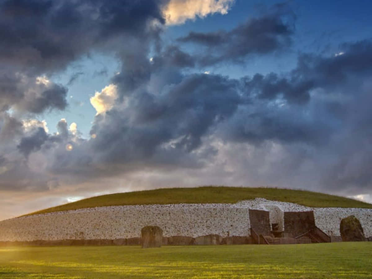 Newgrange, stormy clouds, sunset lighting, SD Desktop Wallpaper
