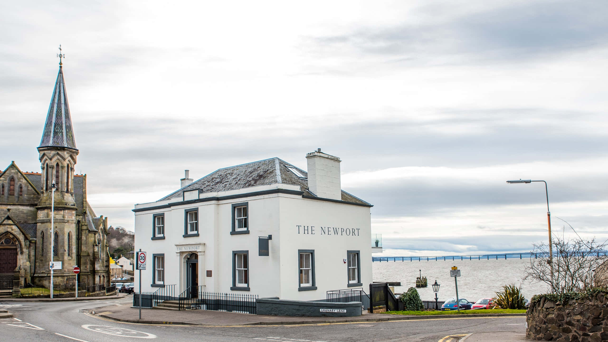 The Newport, stone church, distant bridge, 2K Desktop Wallpaper