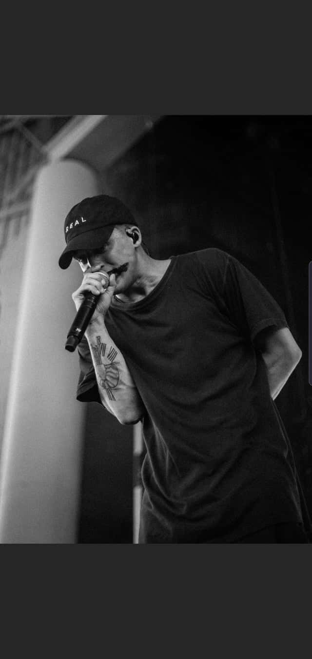 NF Rapper, tattooed man, singing into a microphone, HD Phone Wallpaper