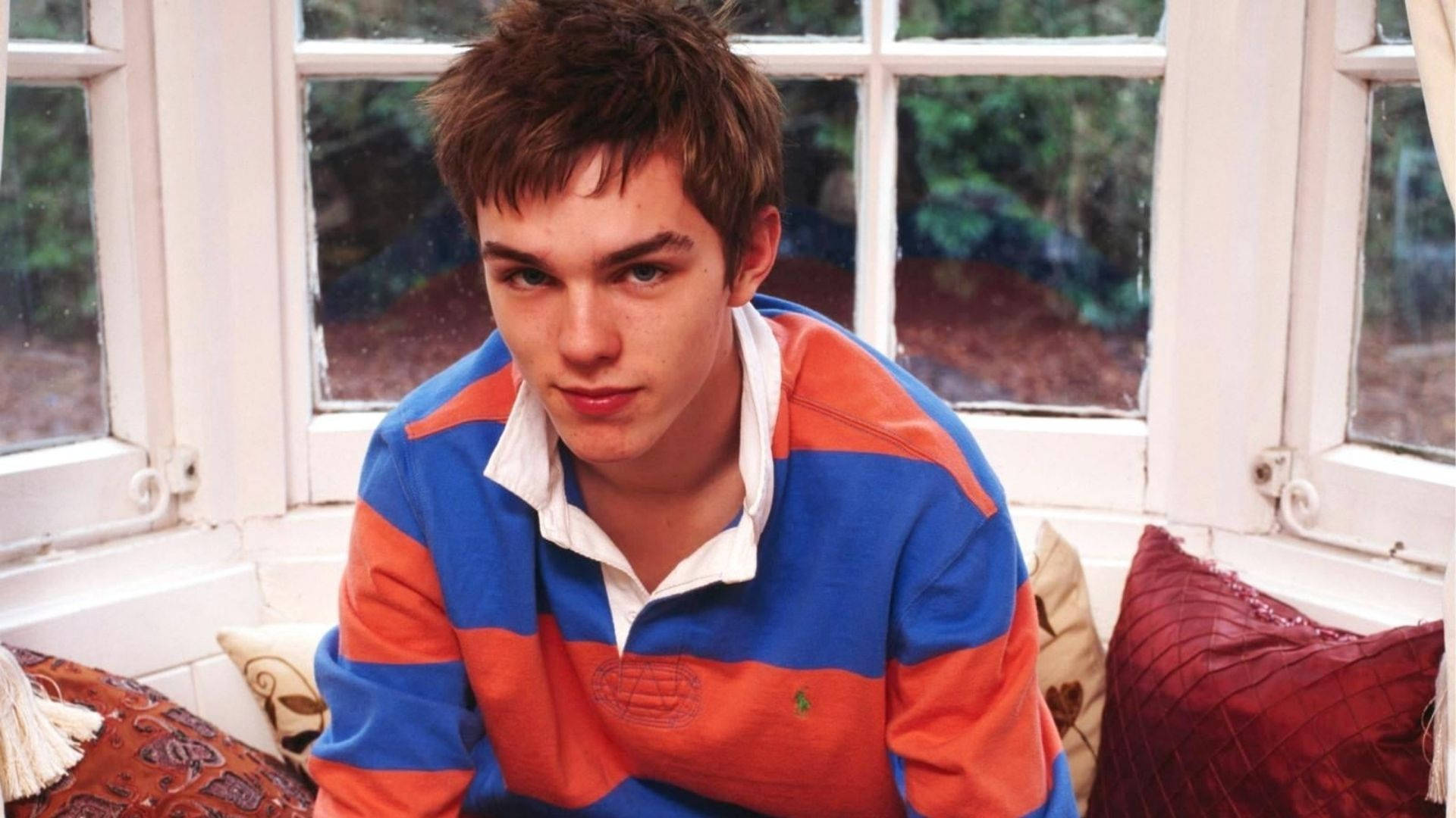 Nicholas Hoult, blue and orange striped polo shirt, window seat, Full HD Desktop Wallpaper