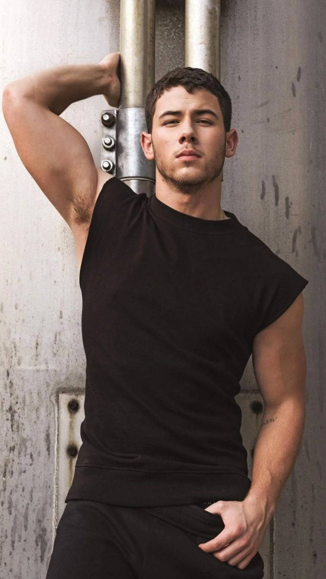 Nick Jonas, black sleeveless shirt, weathered concrete wall, Full HD Phone Wallpaper