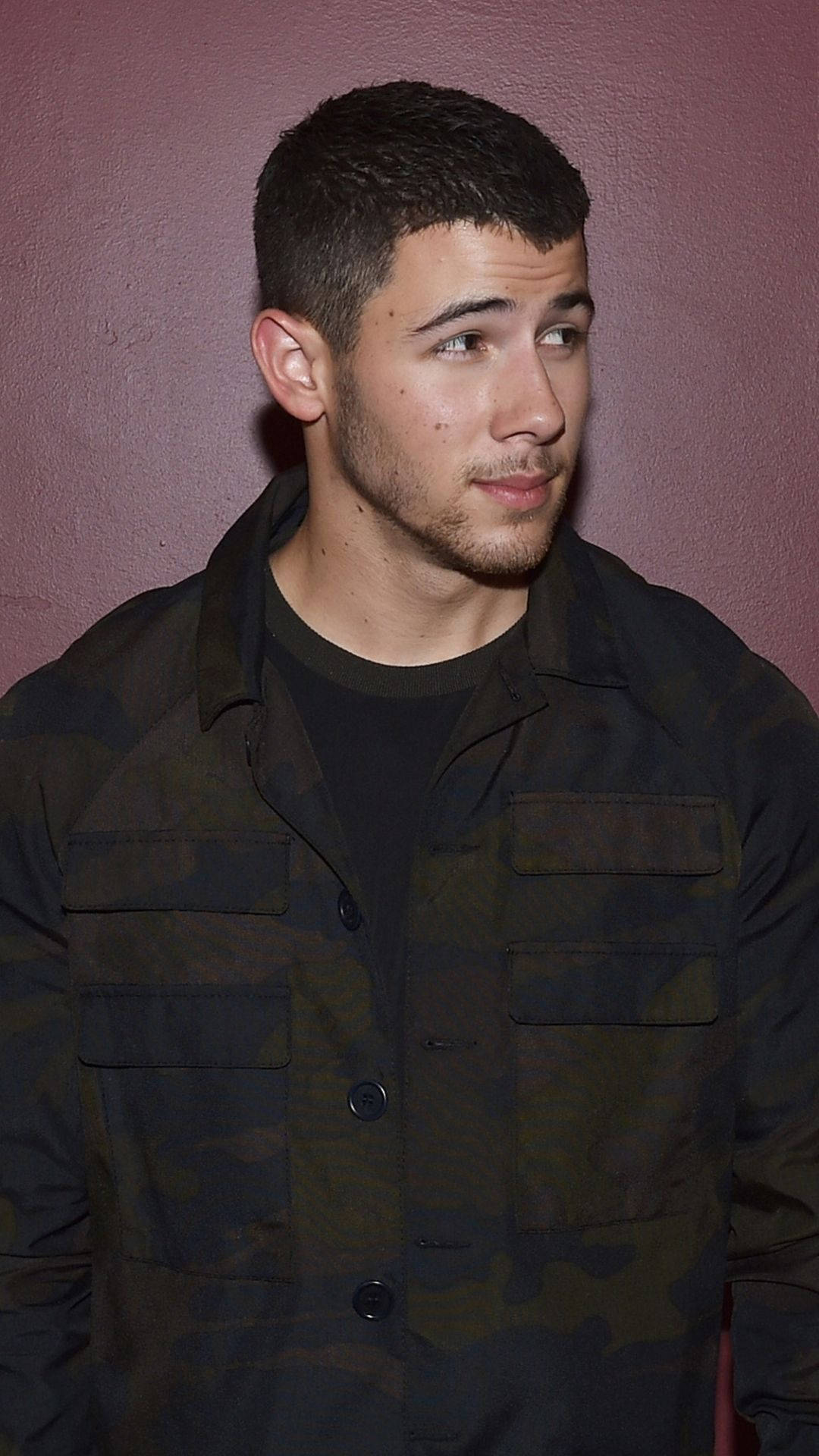 Nick Jonas, camouflage jacket, muted pink wall, Full HD Phone Wallpaper