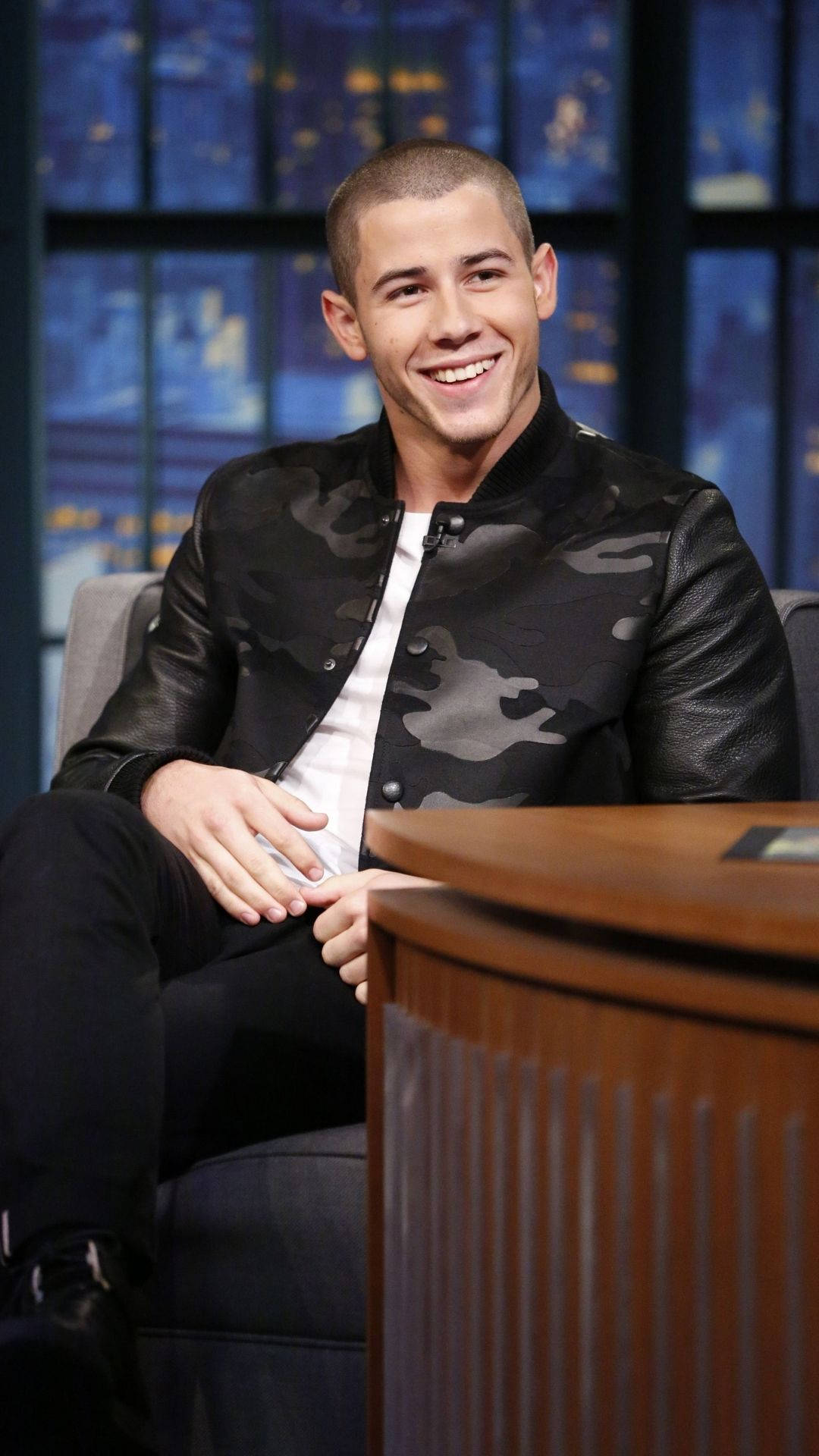 Nick Jonas, black camouflage leather jacket, studio chair, Full HD Phone Wallpaper