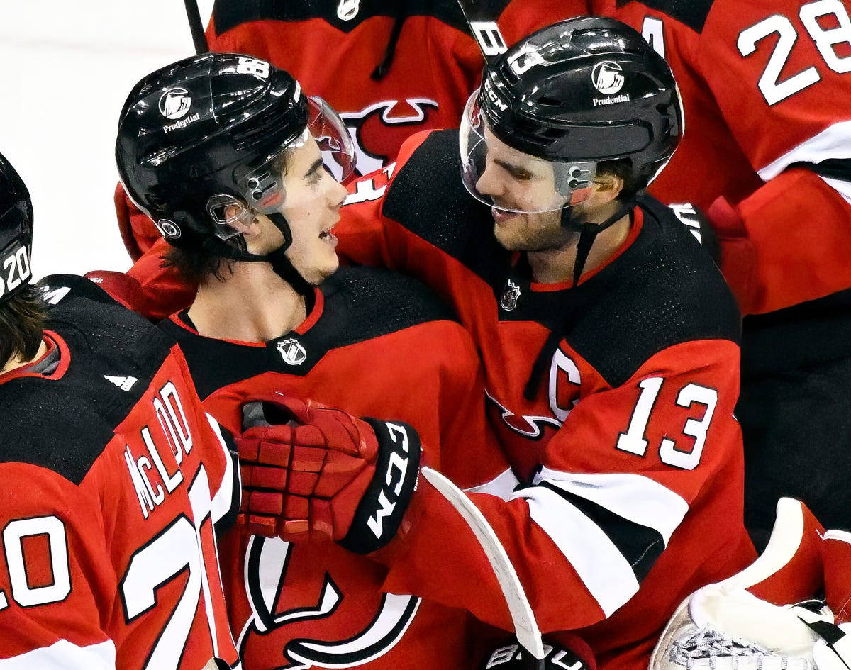 Nico Hischier, red and black jerseys, helmets on, SD Desktop Wallpaper