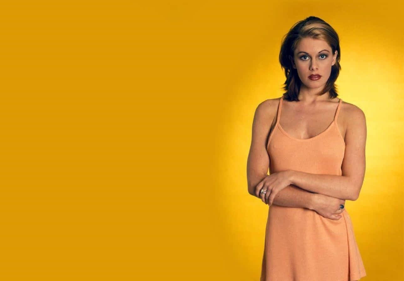 Nicole Eggert, peach dress, vibrant yellow background, HD Desktop Wallpaper