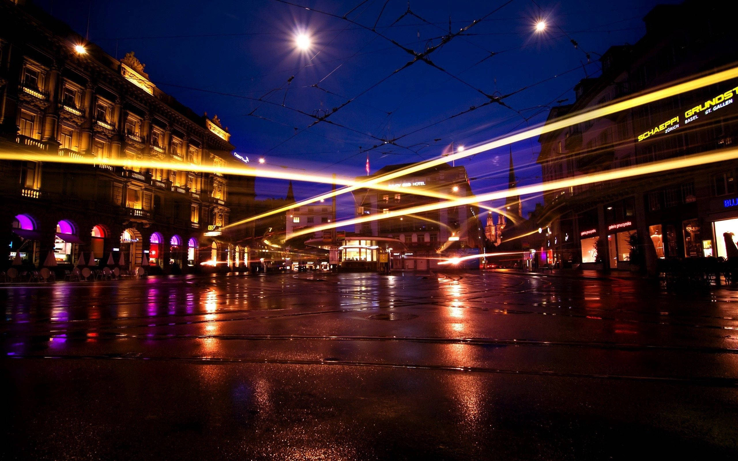 city square, night, rain-slicked, 2K Desktop Wallpaper