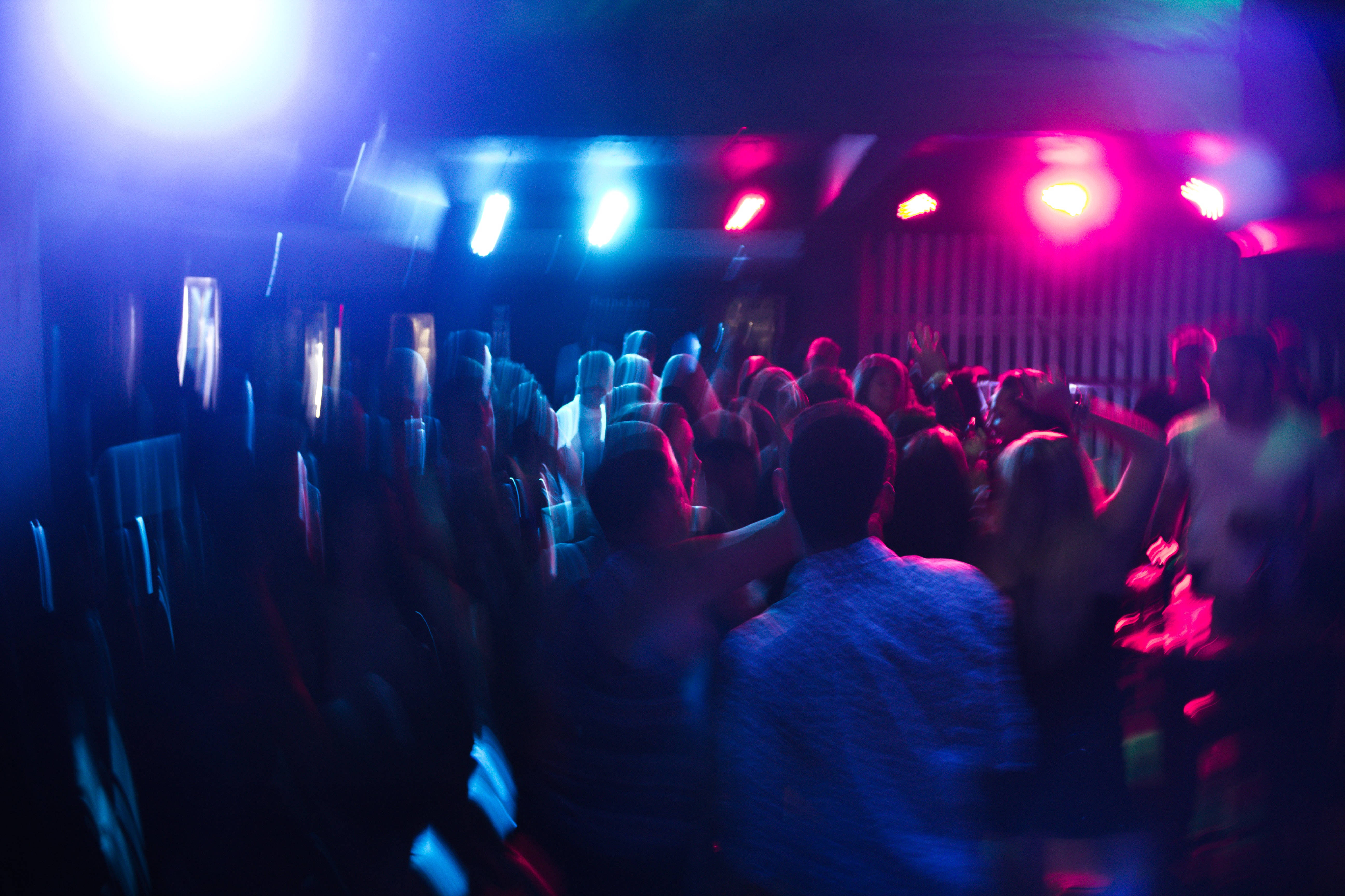 Nightclub, dimly lit, flashing blue and pink lights, 5K Desktop Wallpaper