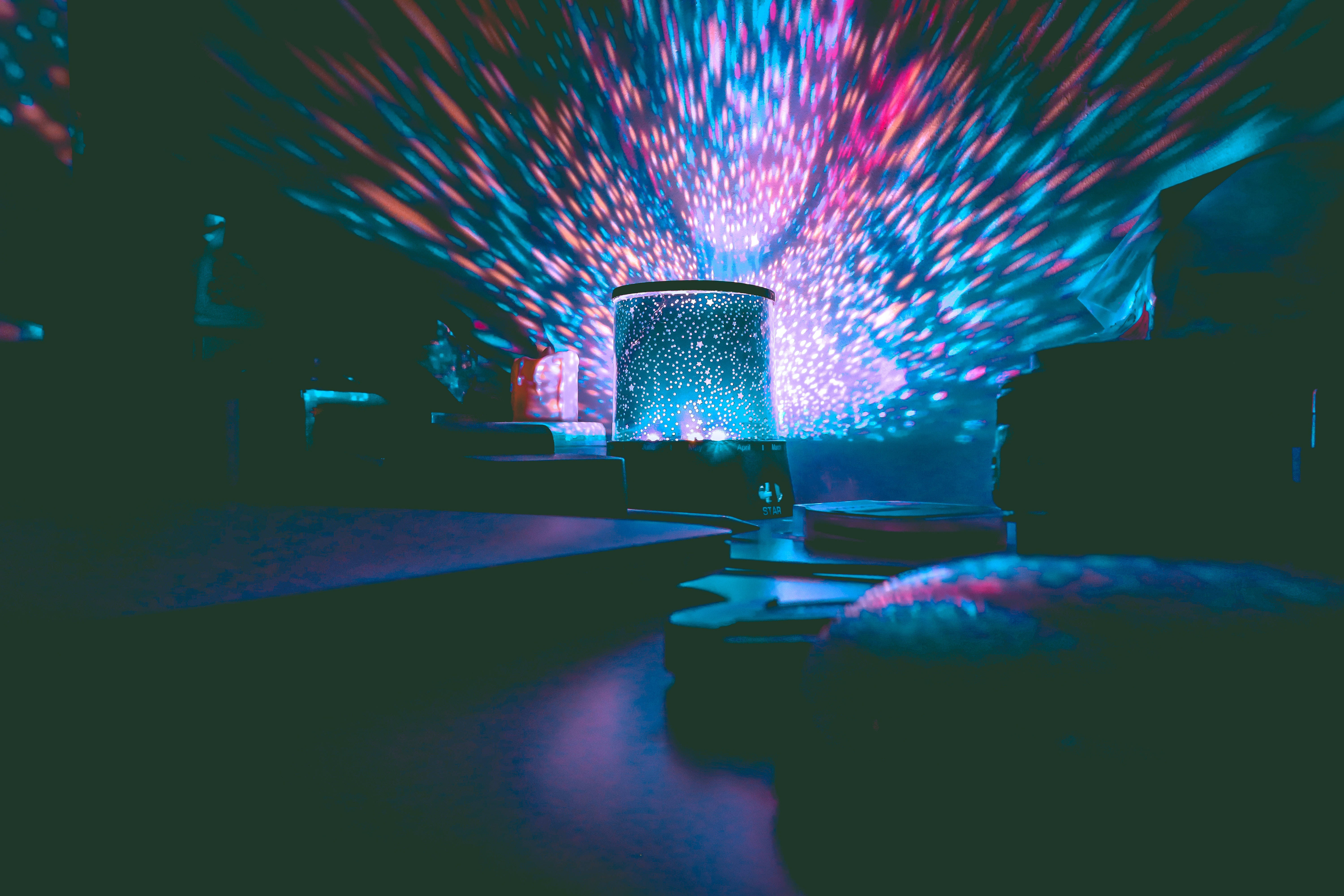 star projector, vibrant blue pink and purple light rays, dark room, 5K Desktop Wallpaper