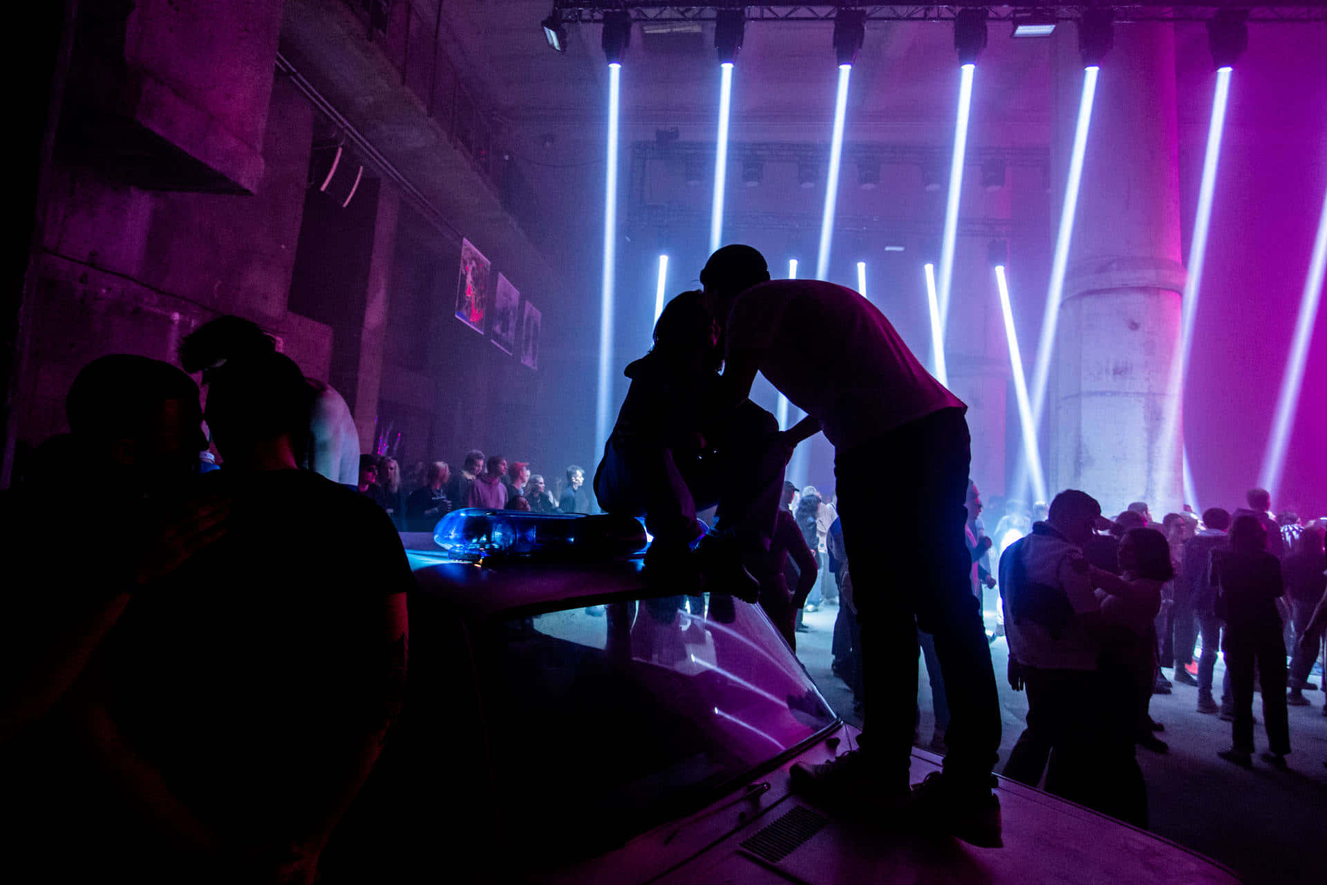 underground venue, vibrant purple and white stage lights, silhouetted figures, Full HD Desktop Wallpaper