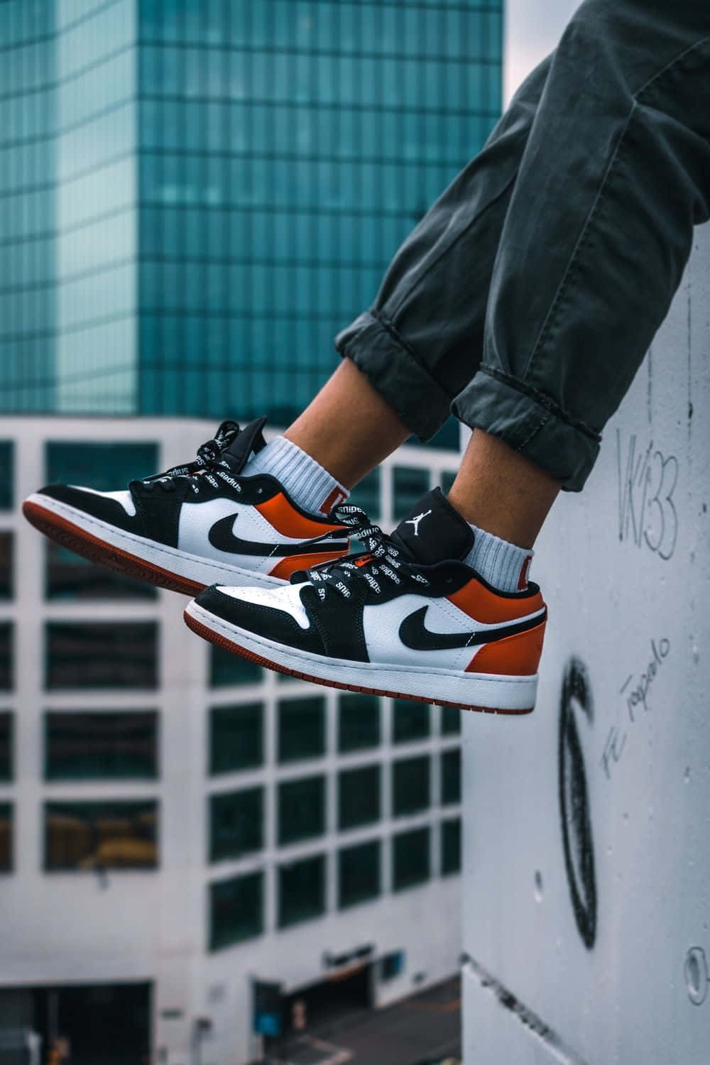 Nike Air Jordan, black white and orange sneakers, graffiti covered wall, HD Phone Wallpaper