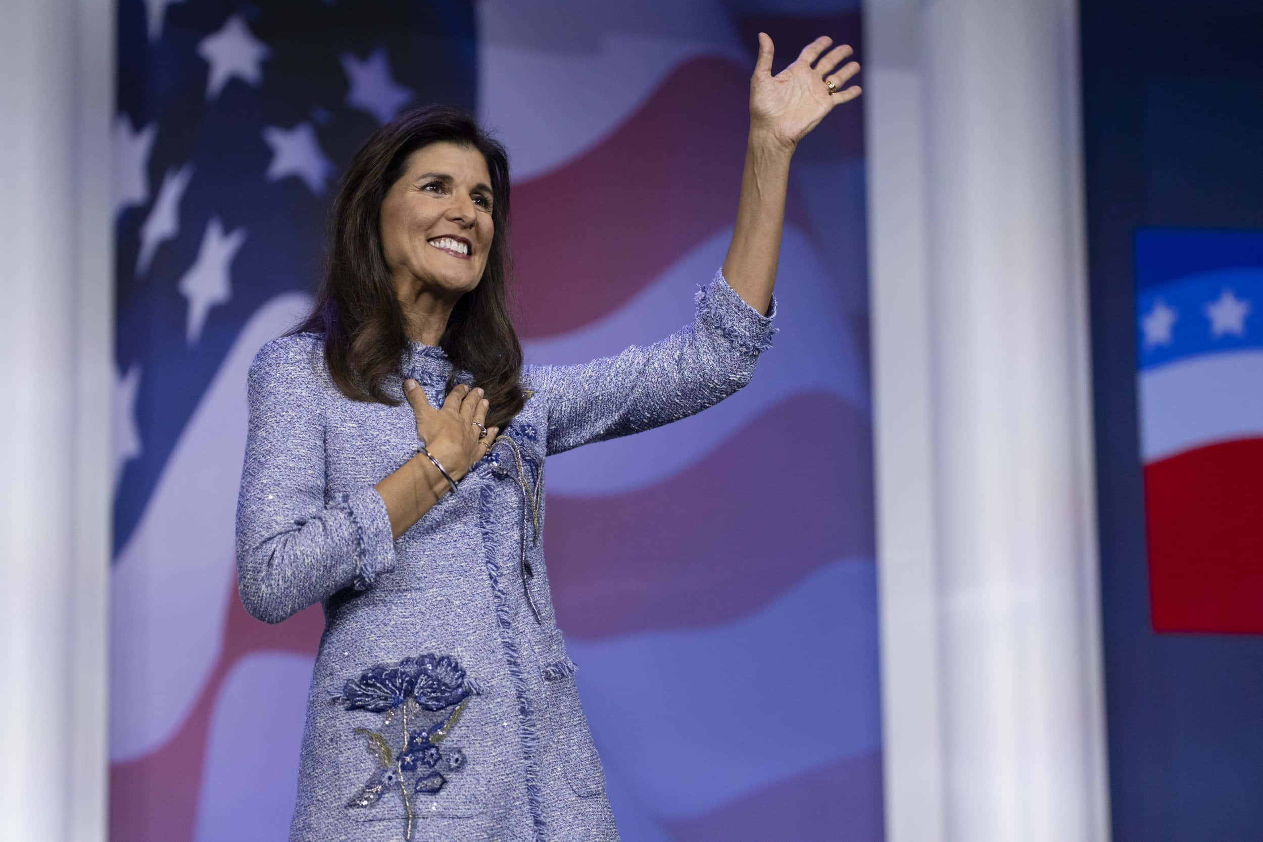 Nikki Haley, blue textured suit, American flag imagery, Full HD Desktop Wallpaper