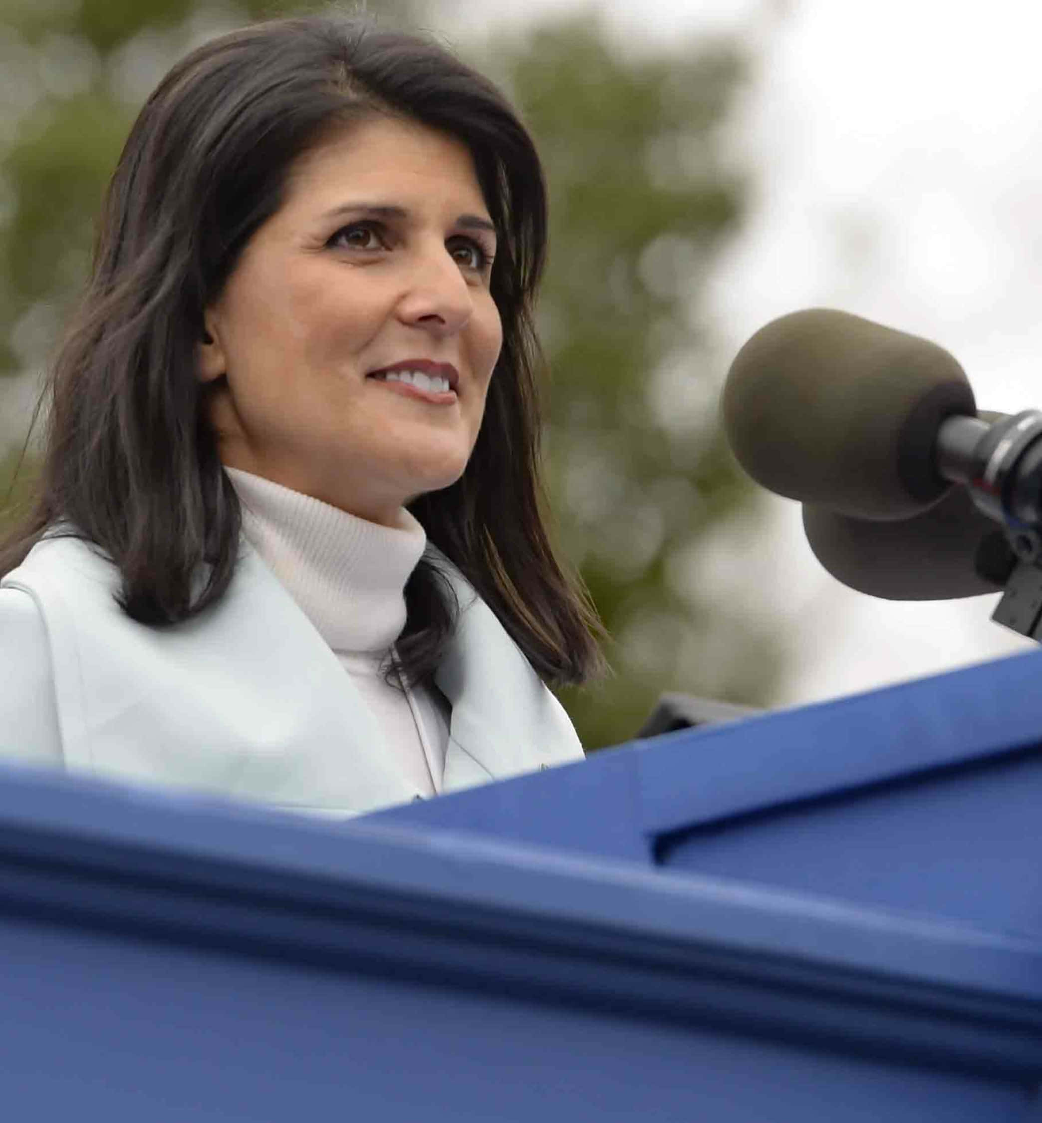 Nikki Haley, white turtleneck, blue podium, Full HD Phone Wallpaper