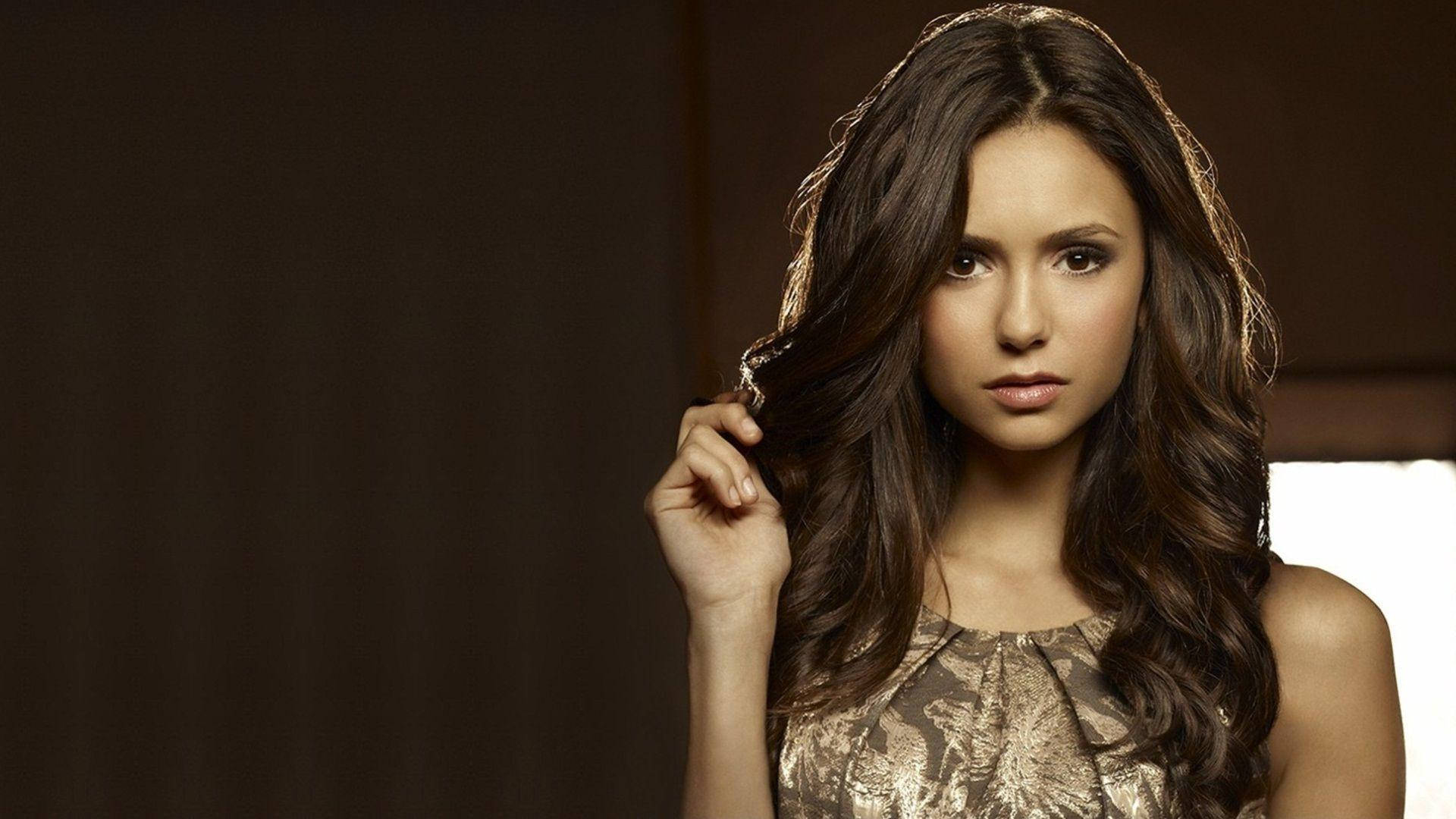 Nina Dobrev, long wavy brown hair, warmly lit indoor setting, Full HD Desktop Wallpaper