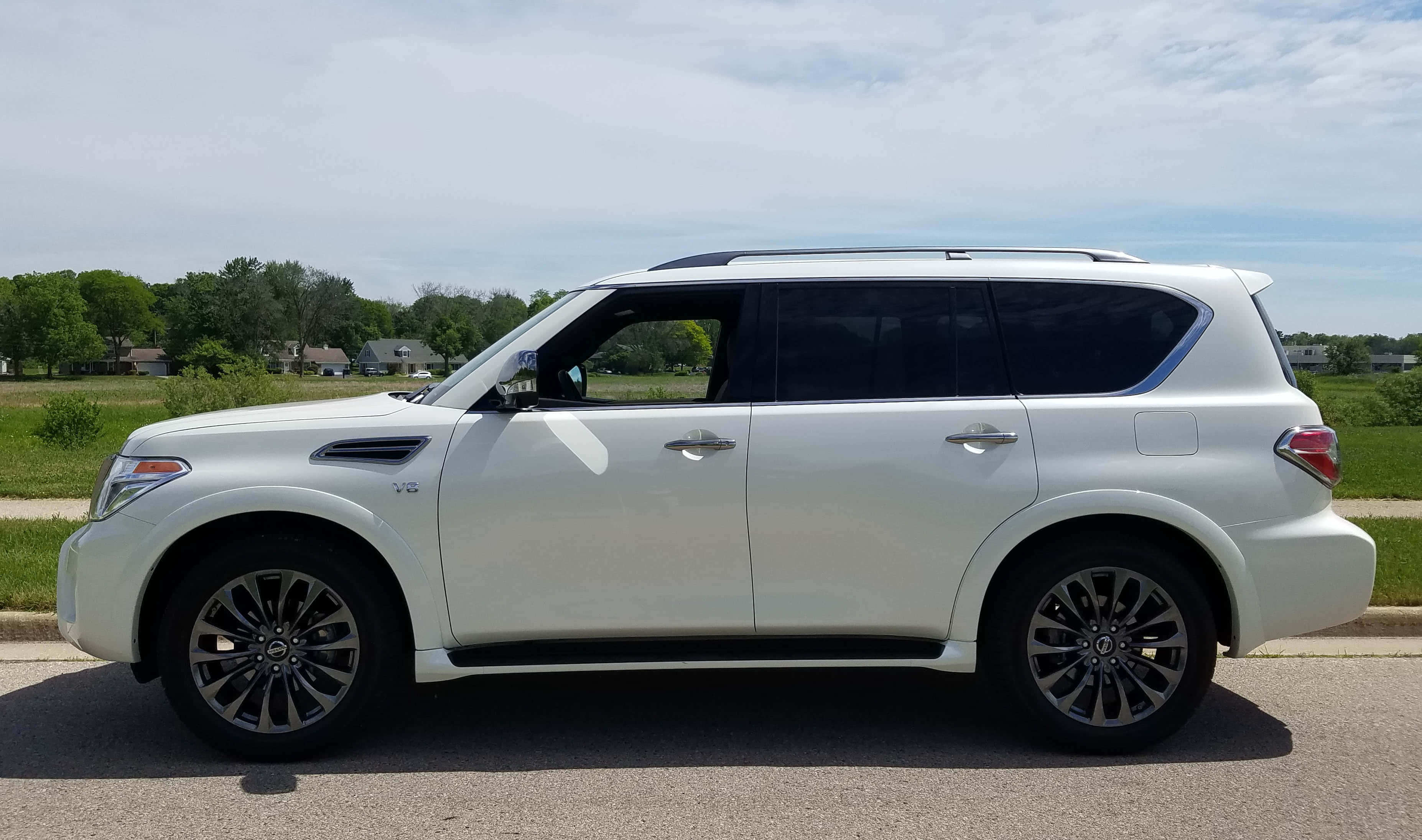 Nissan Armada, pristine white, sleek urban road, 2K Desktop Wallpaper