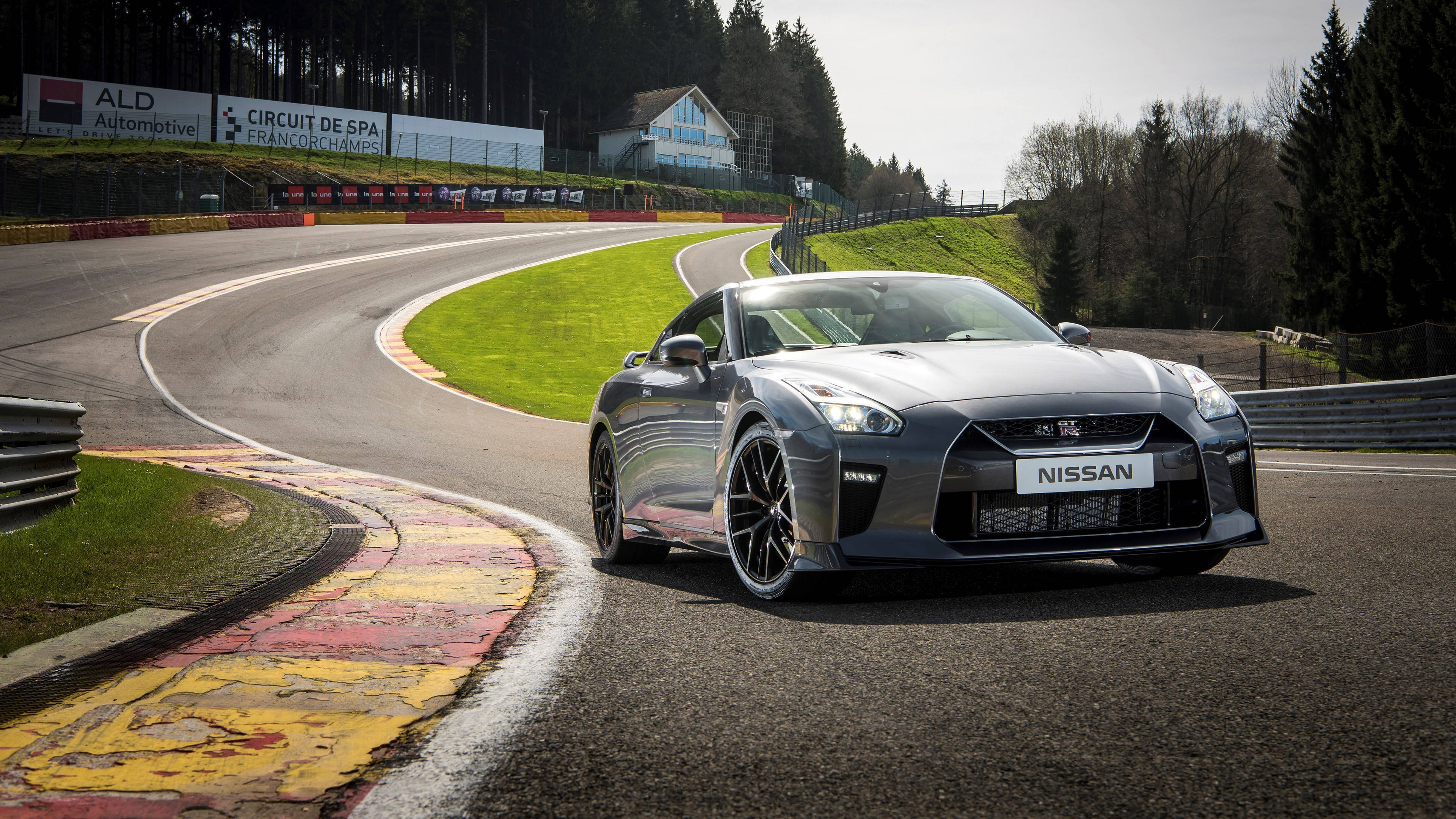 Nissan GT-R, winding asphalt track, green grass, 4K Desktop Wallpaper