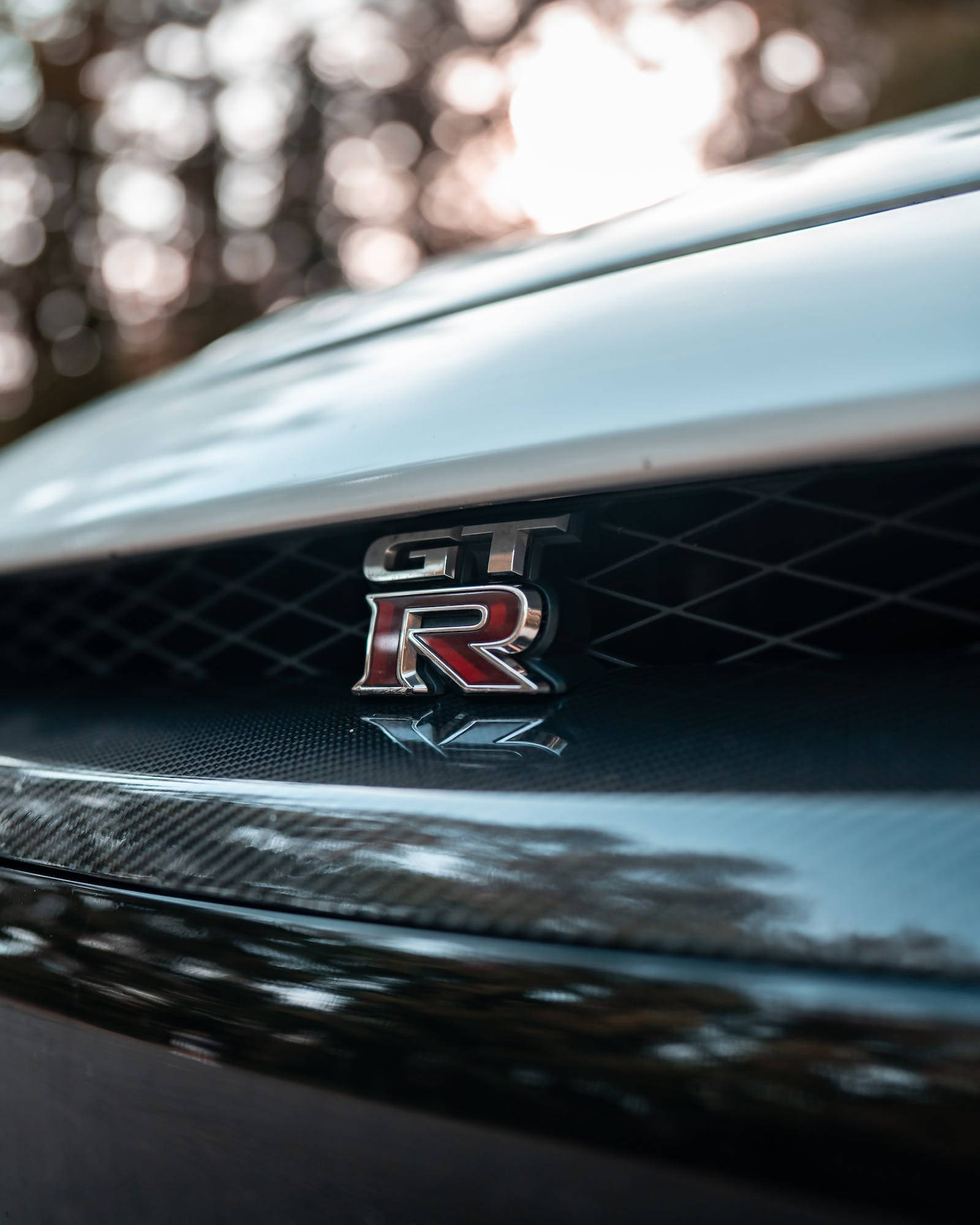 Nissan GT-R, emblem, sleek sports car hood, Full HD Phone Wallpaper