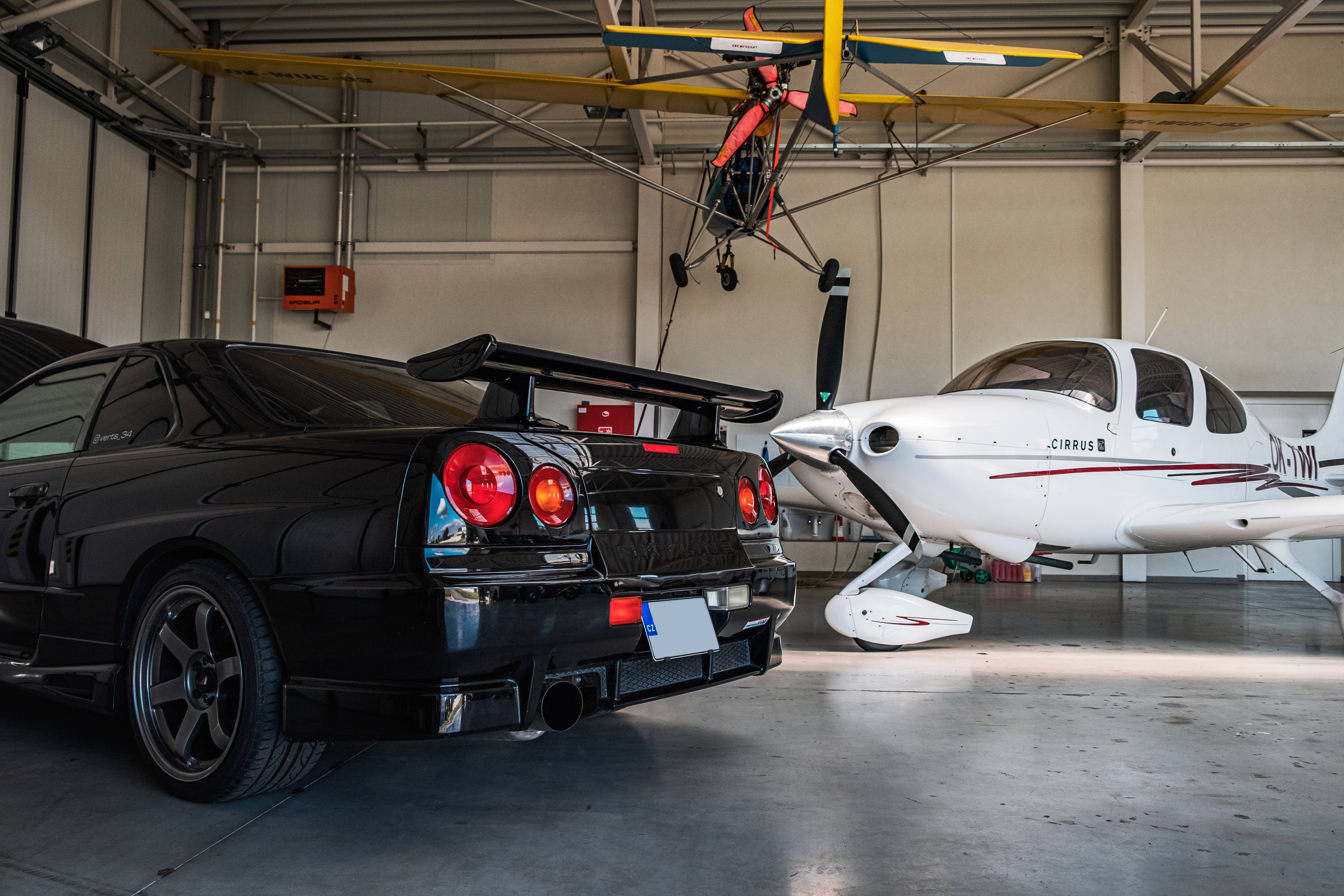Nissan Skyline GTR R34, hangar, black sports car, 5K Desktop Wallpaper