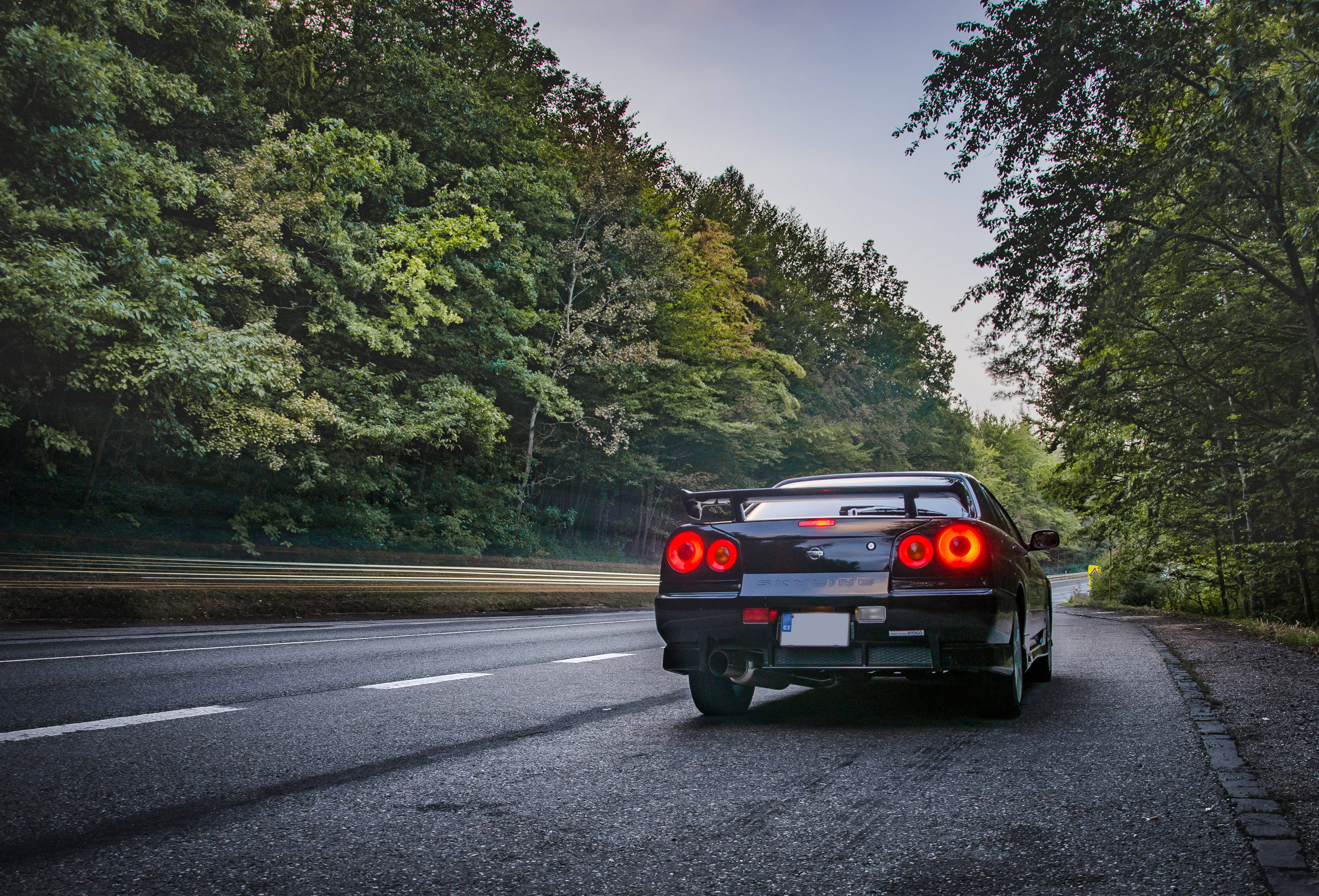 Nissan Skyline GTR R34, black, glowing red taillights, 4K Desktop Wallpaper