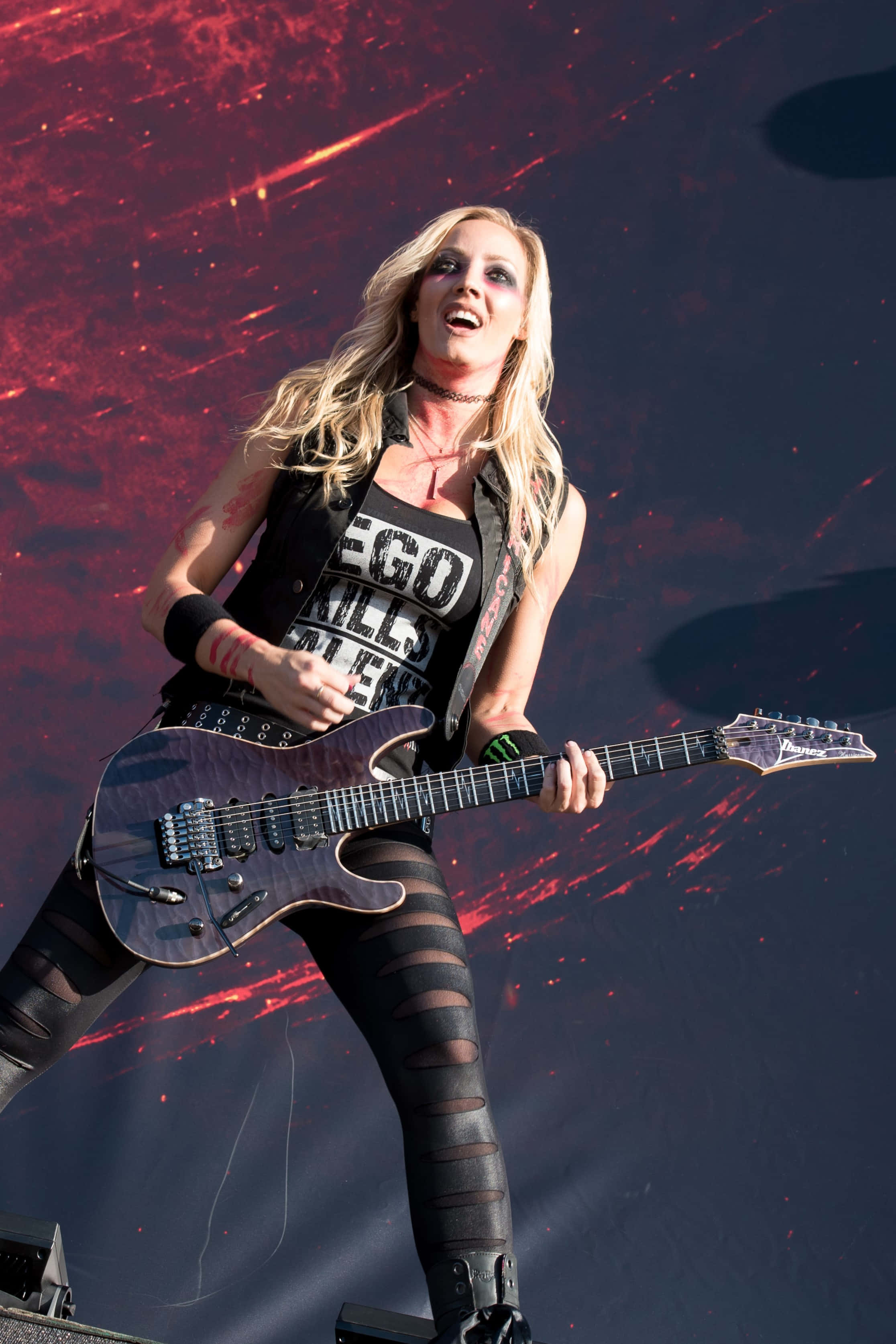 Nita Strauss, purple electric guitar, red and black cosmic backdrop, 2K Phone Wallpaper