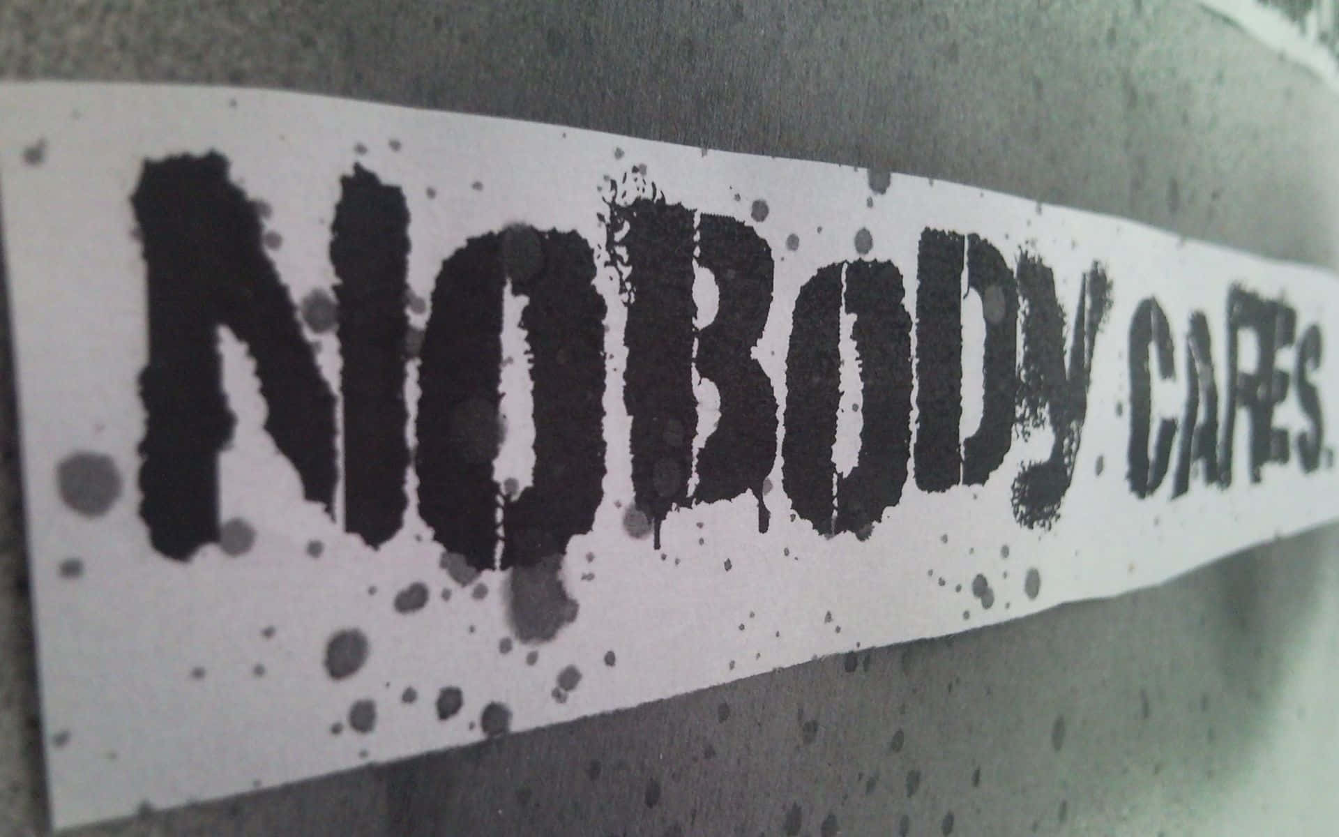 NOBODY CARES, white paper sticker, bold black stenciled text, Full HD Desktop Wallpaper