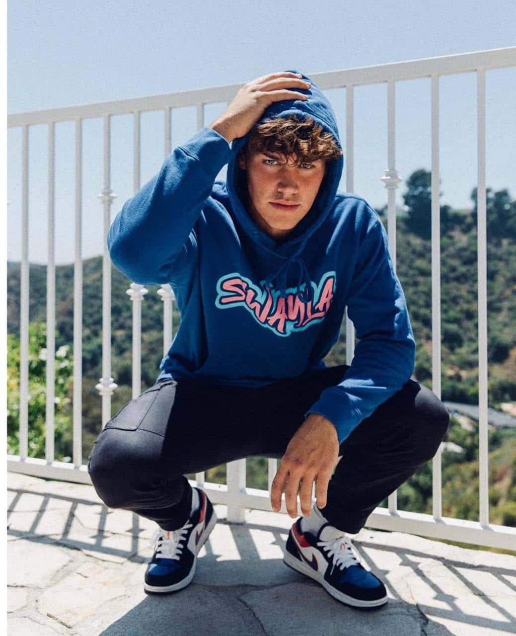 Noah Beck, blue hoodie, sunlit balcony, HD Phone Wallpaper