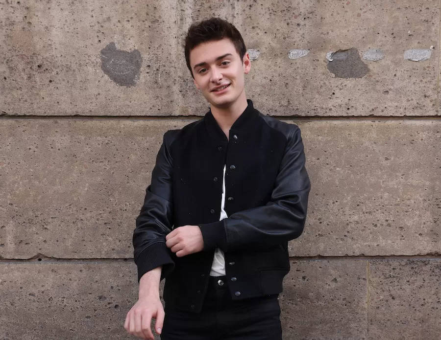 Noah Schnapp, black bomber jacket, textured concrete wall, SD Desktop Wallpaper