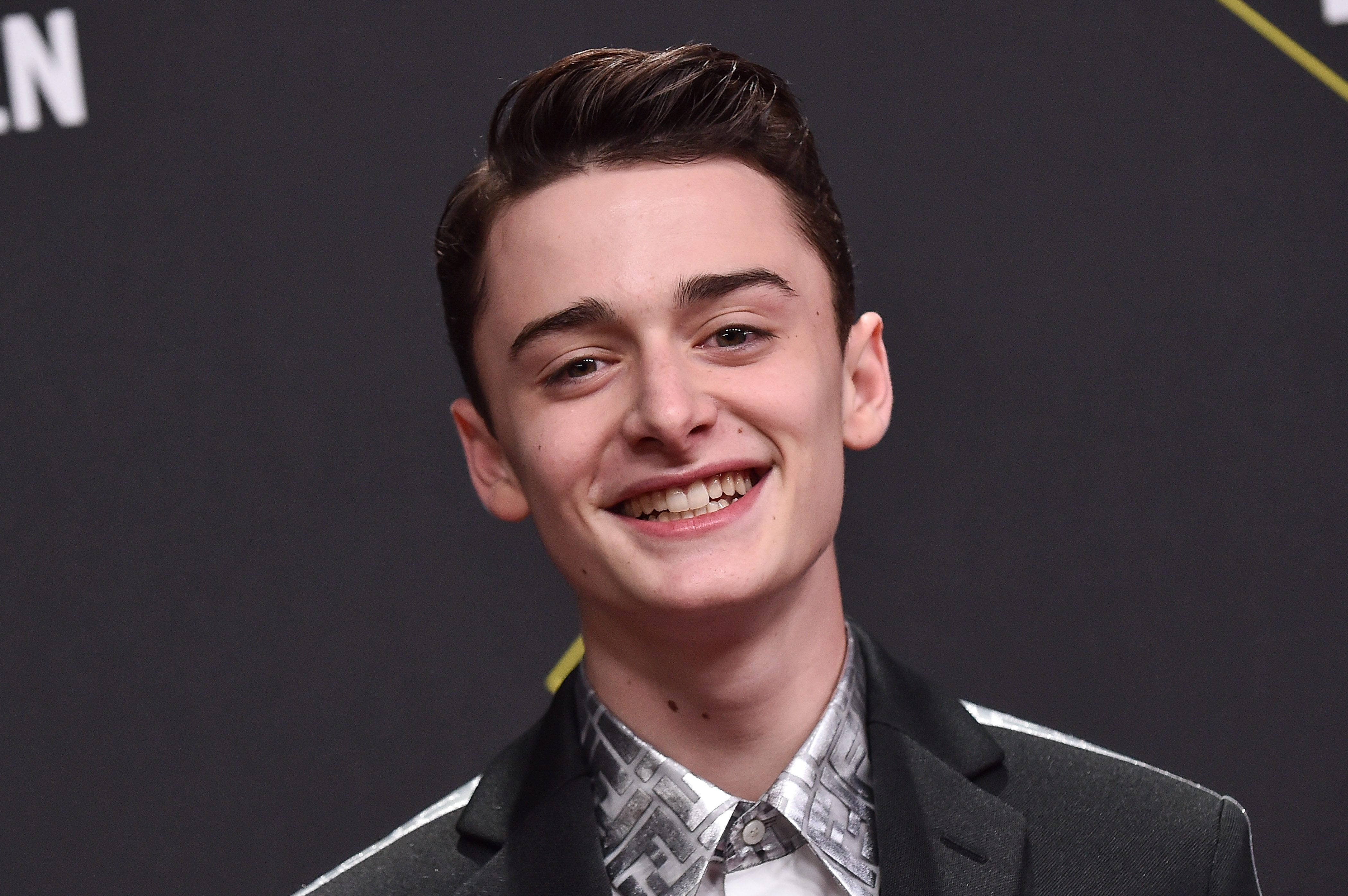 Noah Schnapp, dark backdrop, sharp suit, 4K Desktop Wallpaper